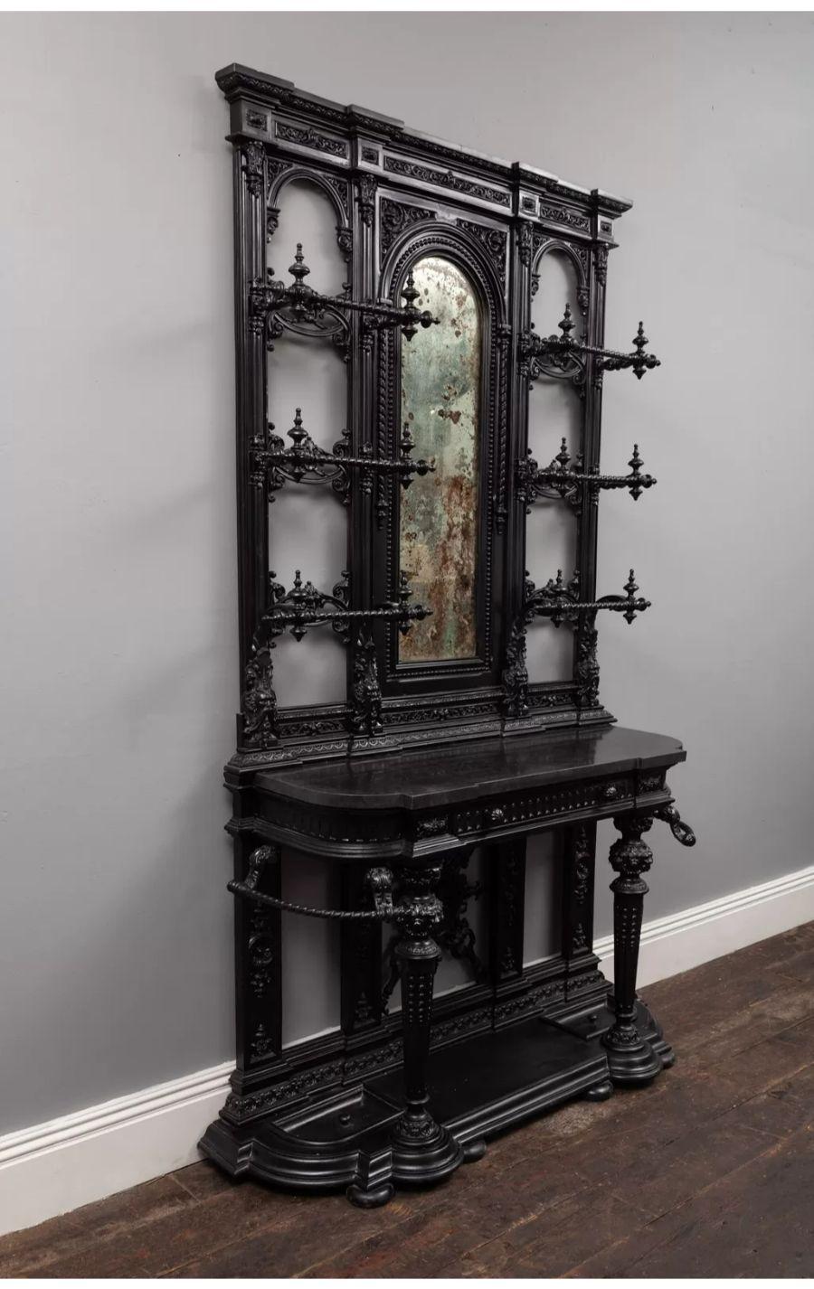 An exceptional antique Victorian cast-iron hall stand by Coalbrookdale.

With black Kilkenny marble top, coat hooks, stick stands, removable umbrella drip trays and original mirror.

Large in scale and highly decorative, having the finest quality