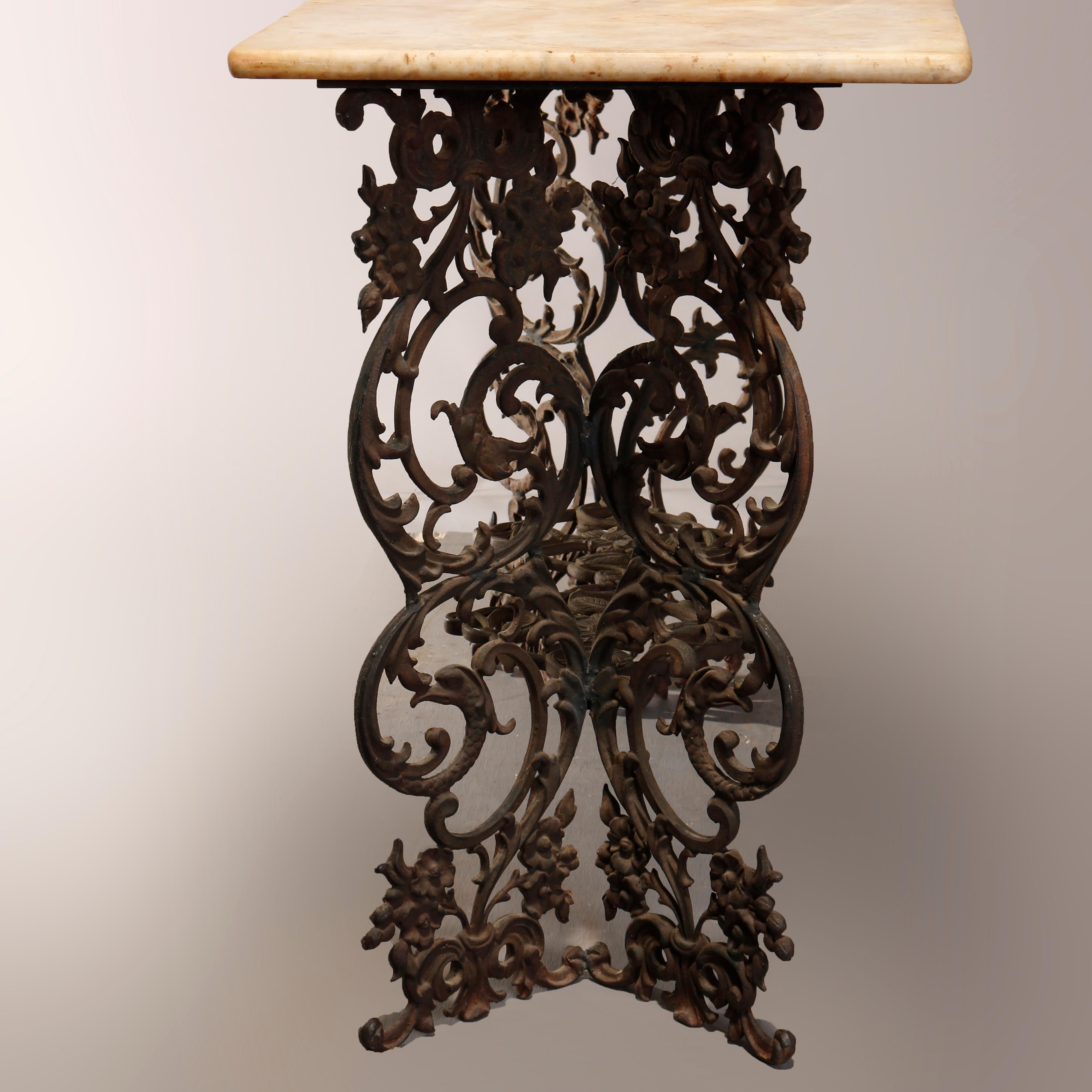 An antique Victorian garden table offers scroll and foliate form cast iron base surmounted by marble top, circa 1890

Measures: 30.5