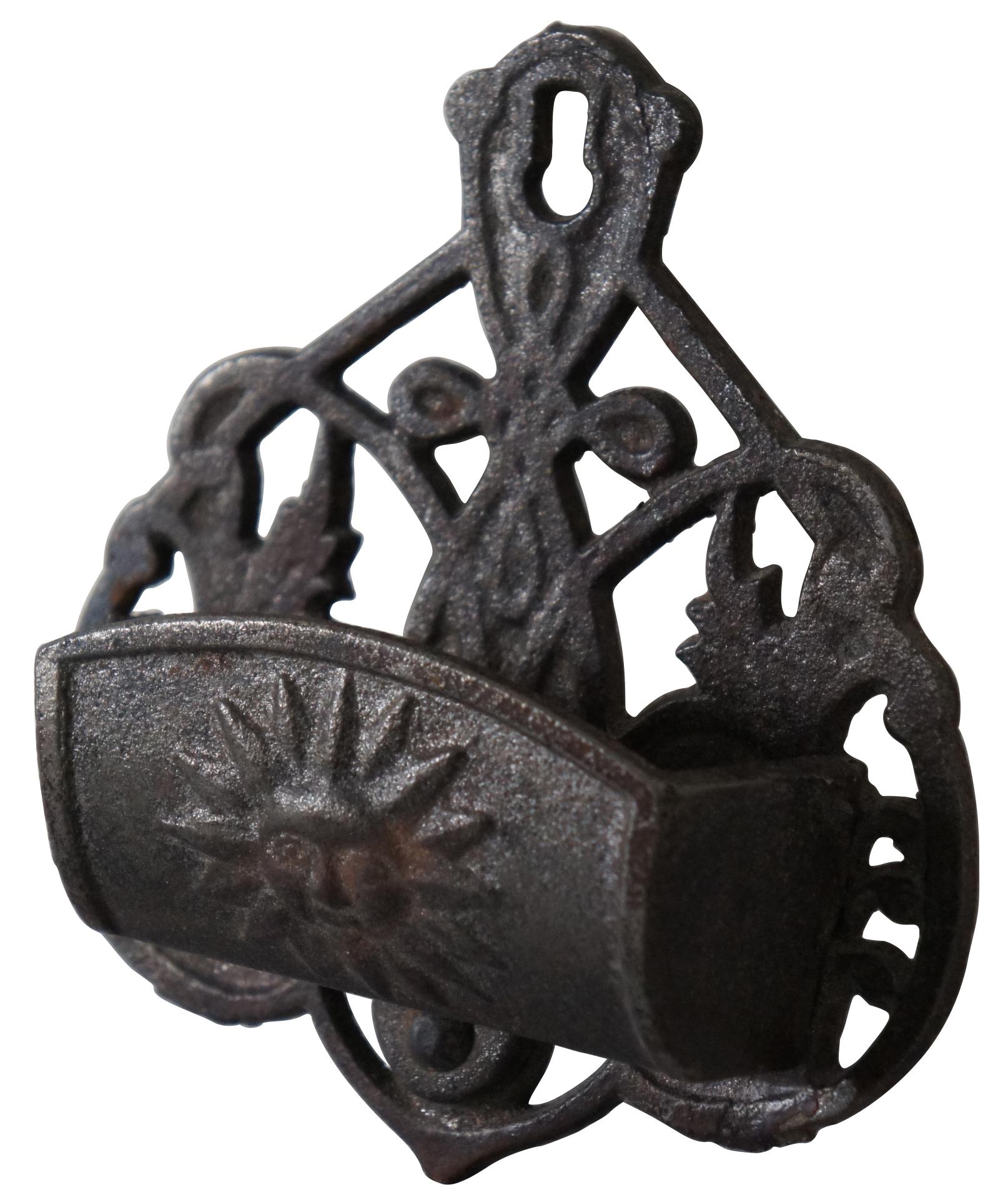 Antique cast iron match safe with Celtic knot inspired wall plate and sun with a face on the front.
 