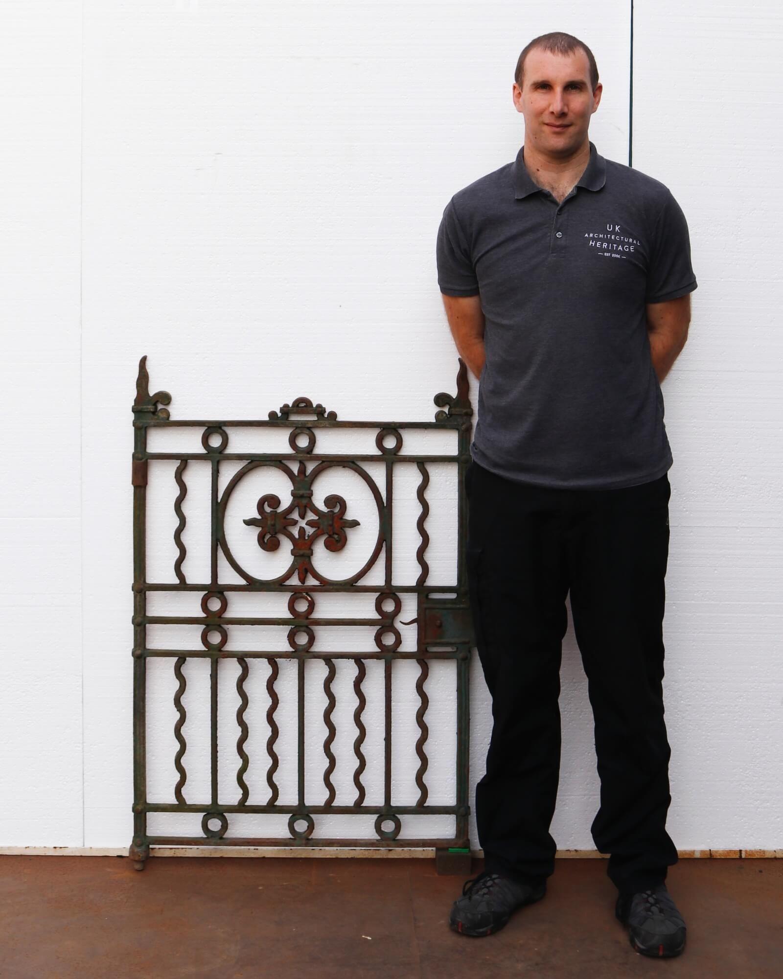 Antique Victorian cast iron pedestrian gate with a light rust finish. This 19th century gate showcases an alternative looking style of the Victorian era, with its wavy elements, and green like colour. Another feature of this iron gate is has an