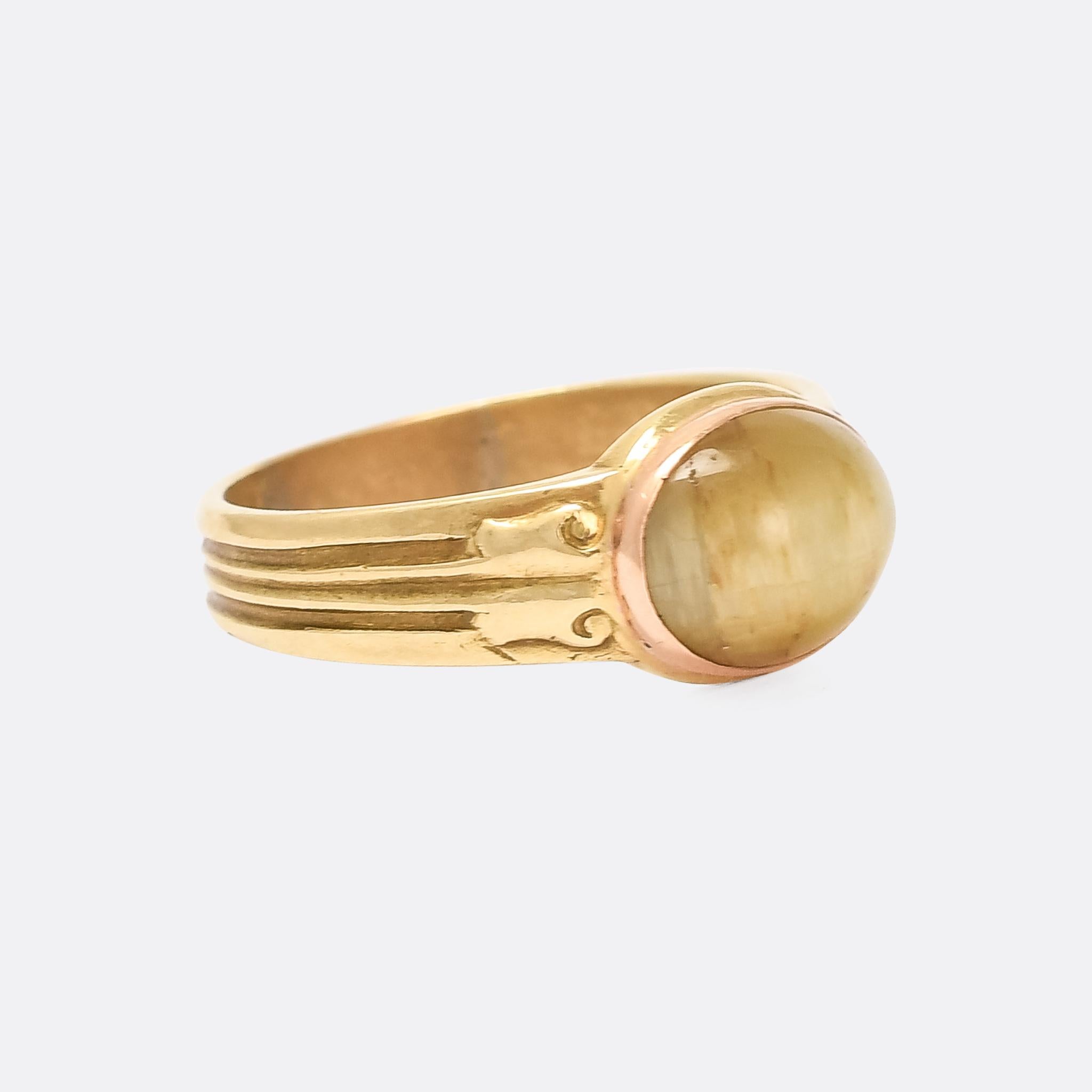 A superb Victorian Cat's Eye ring dating from the latter half of the 19th Century. The principal stone is an oval cabochon, displaying great chatoyancy as it's moved through the light. The ring mount is crafted in 18 karat gold, and features