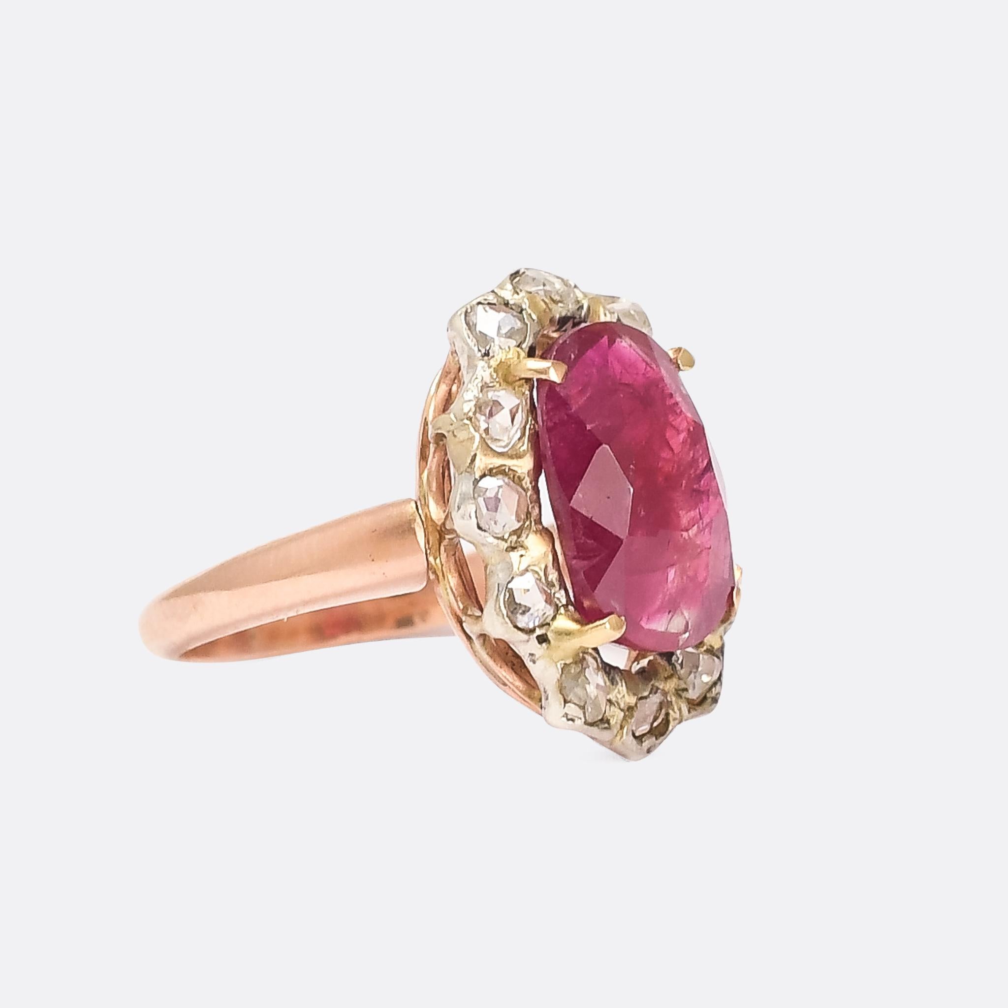 A superb antique Burma ruby and diamond cluster ring dating from the late Victorian period. It's set with a stunning 4.98 carat natural Burmese ruby, certified with no indication of heat treatment. The principal stone is surrounded by a halo of rose