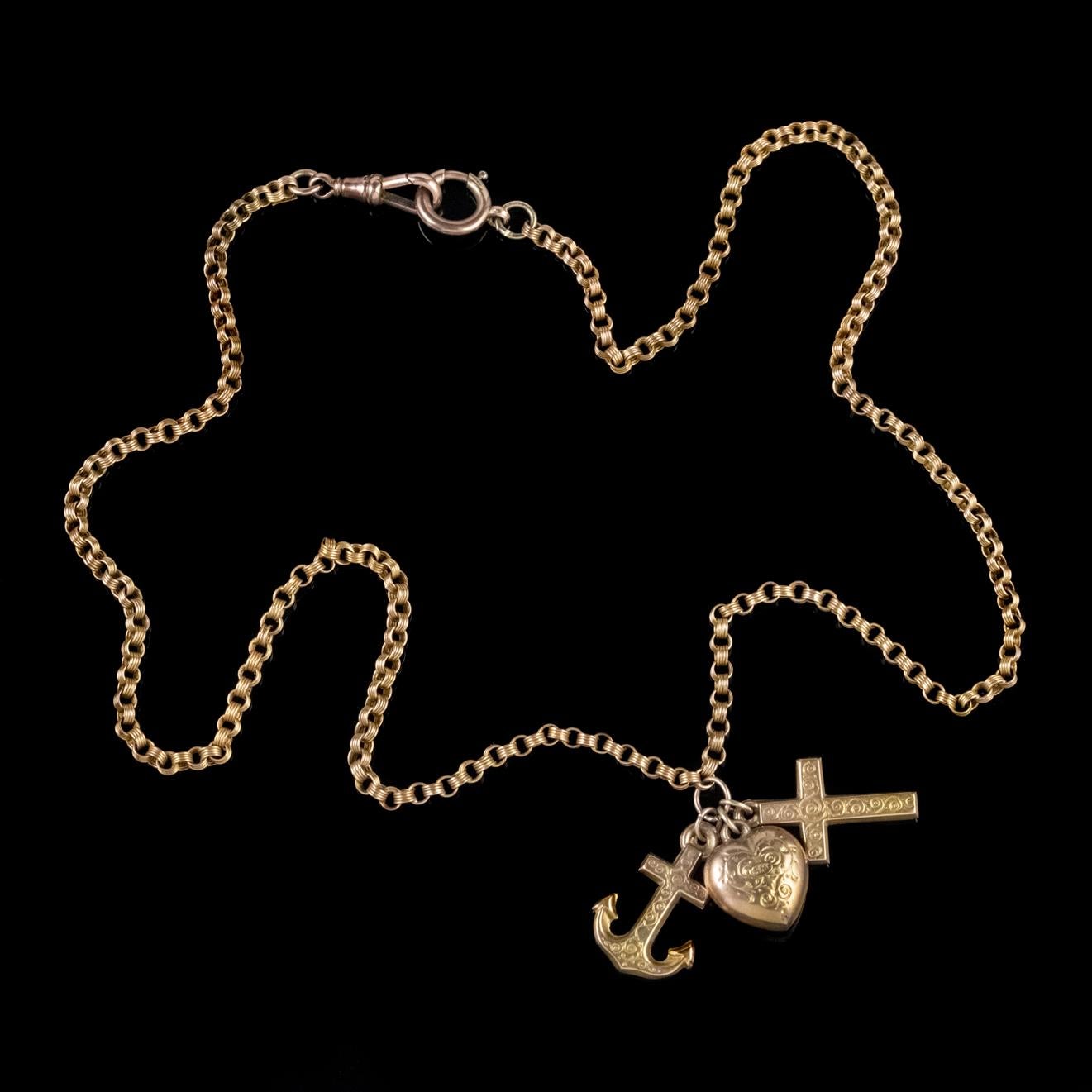A wonderful antique Victorian chain necklace featuring three lovely charms in the shape of an Anchor, Cross and Heart which display beautiful engraved detailing.

The charms represent the three great virtues in the new testament with the Cross