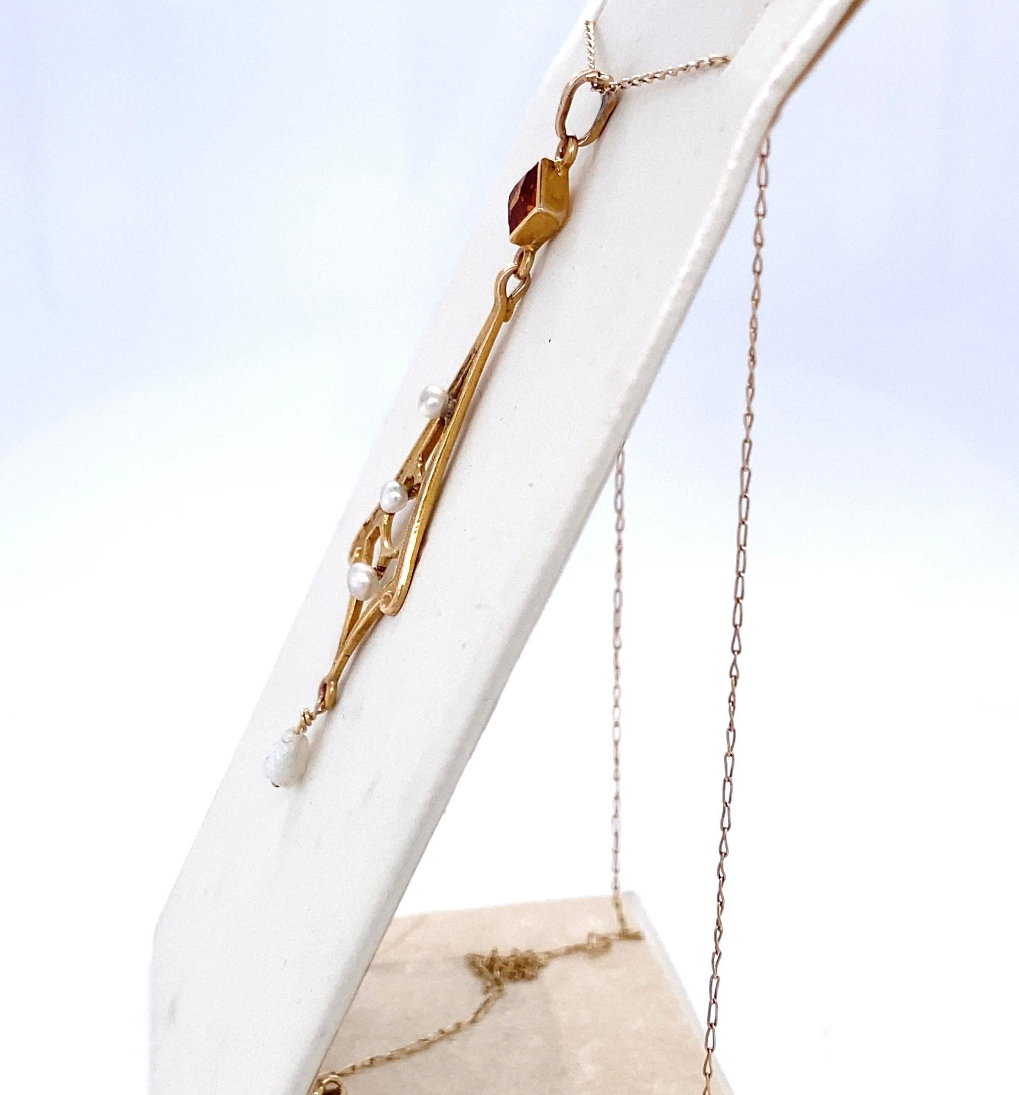 Here's a fun pendant in 14 karat yellow gold, citrine and pearl.  Dating back to the turn-of-the-century, this lovely Victorian era lavaliere pendant artfully blends two beautiful gems - an approximately 0.25 carat square faceted bezel set citrine,
