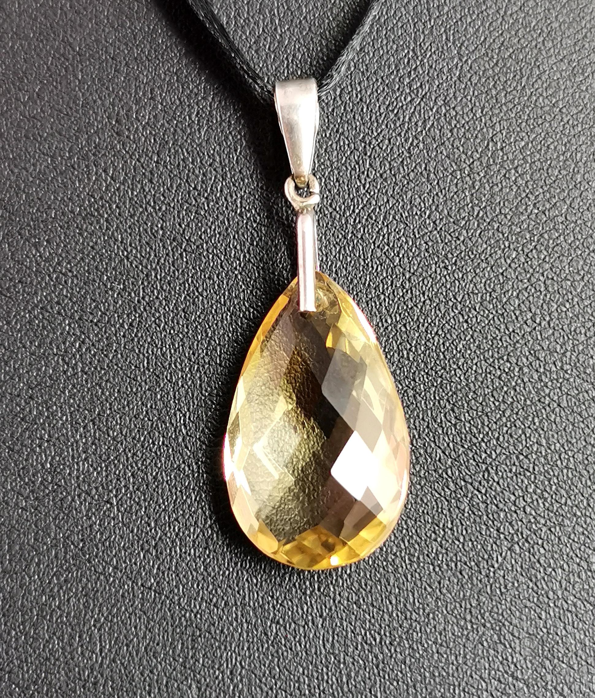 A beautiful antique, late Victorian teardrop shaped citrine briolette pendant. .

A beautiful lemony yellow citrine suspended from a sterling silver bale.

The briolette cut is a most beautiful cut for gemstones, a hard cut to master, it provides