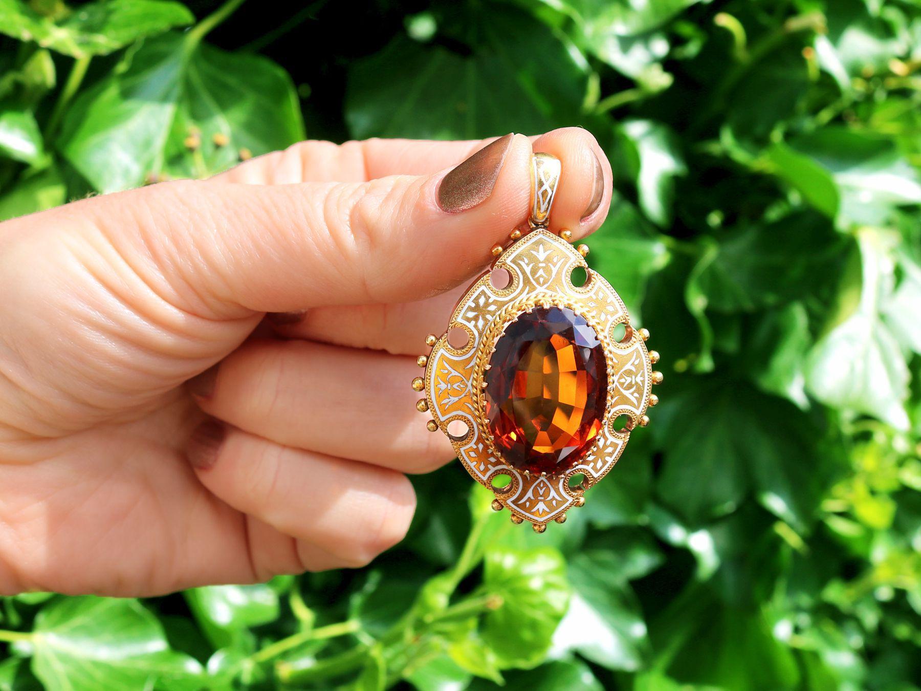 A stunning, fine and impressive antique Victorian 21.63 carat citrine, enamel and 18 karat yellow gold pendant; part of our diverse antique jewelry and estate jewelry collections.

This stunning, fine and impressive antique pendant has been crafted