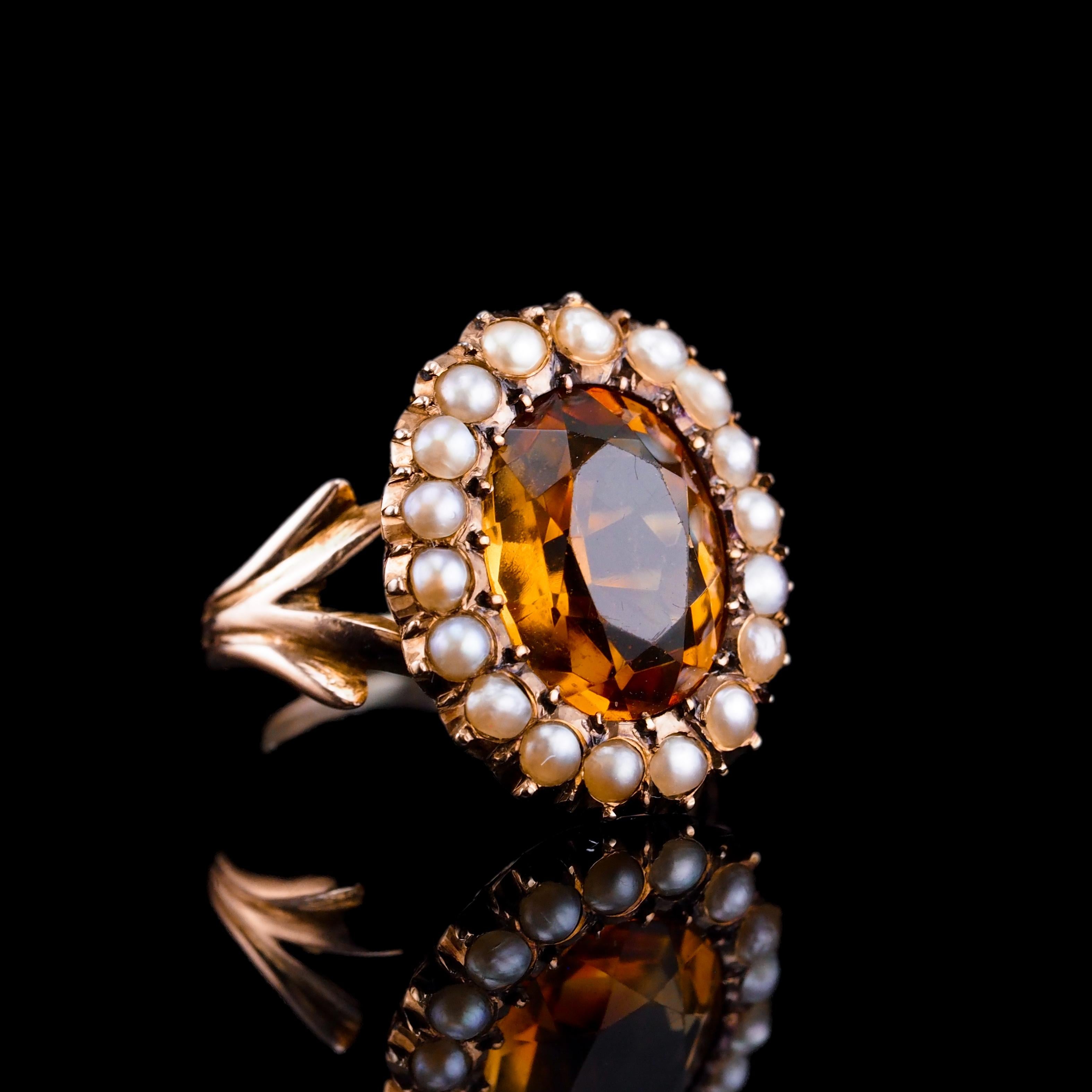 We are delighted to offer this fabulous antique Victorian citrine and seed pearl ring made c.1890.Immediately upon first glance, the citrine's transparent yet rich honey-like colour captivates the eye.
  
Surrounding the central faceted citrine, a