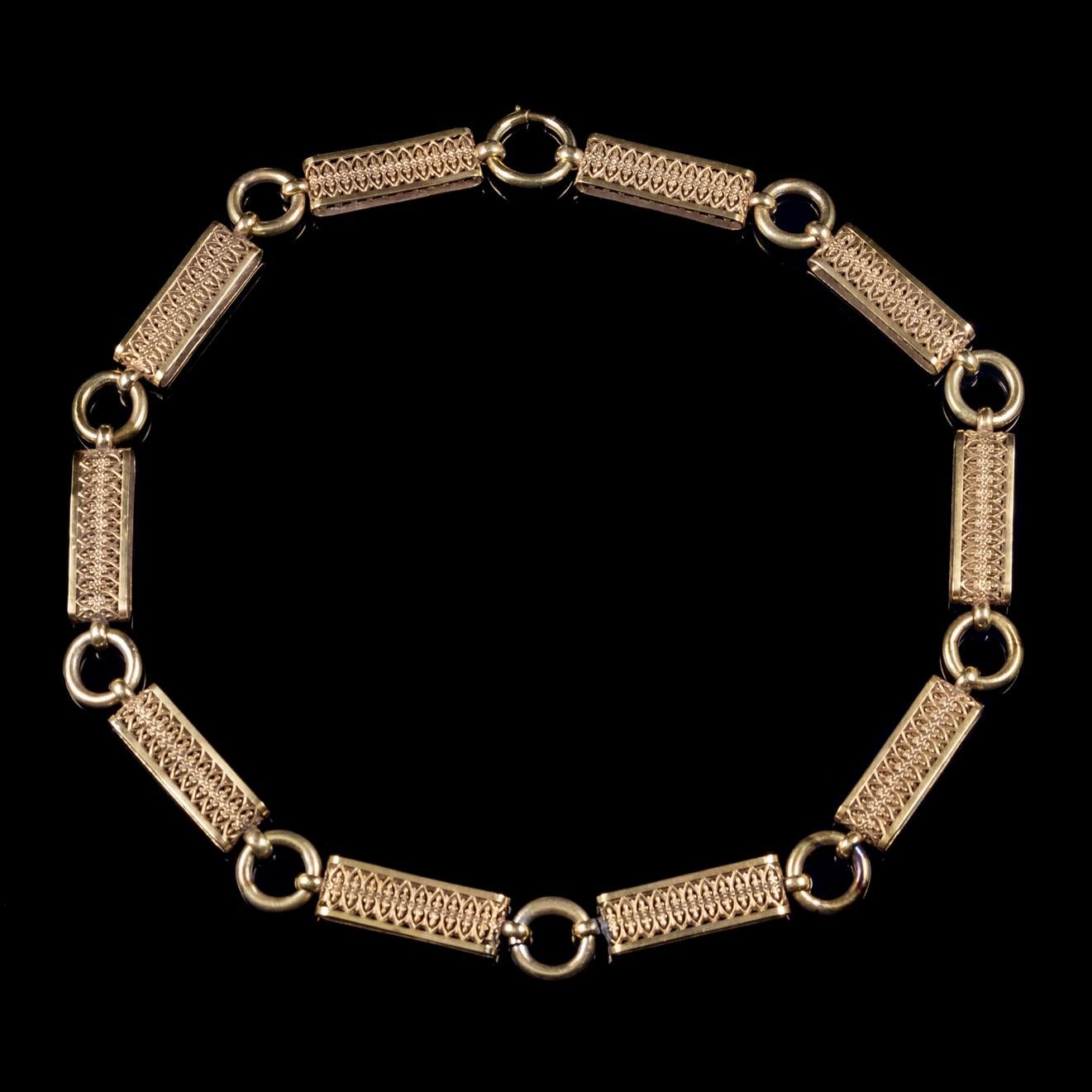 This grand antique collar necklace is from the Victorian era, Circa 1880.  

The piece is made up of fancy rectangular links engraved with a beautiful patterned design and interlinked with Gold rings. 

All set in Silver and gilded in 18ct Yellow