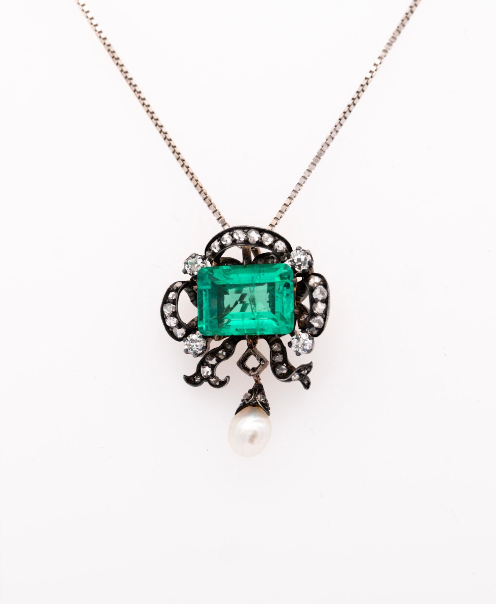 Expert craftsmanship and magisterial gemstones from a bygone era, the Victorian period. This silver pendant bears a 3.65 carat (approx.) emerald center stone, adorned with 34  old mine and single cut diamonds, and finally complemented with a
