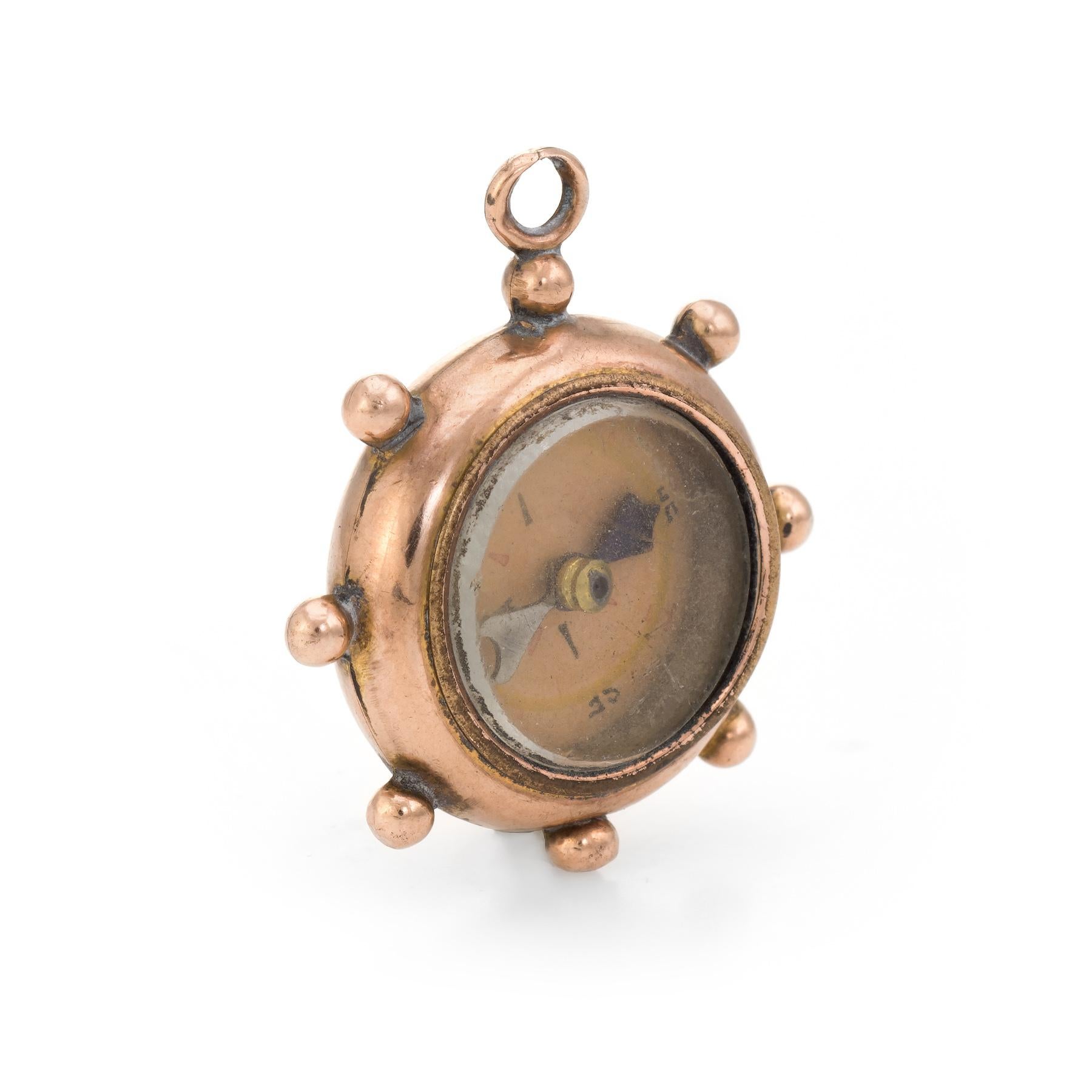 Finely detailed antique Victorian compass fob crafted in 9k rose gold (circa 1897).   

Originally the compass would have been worn alongside a pocket watch. The ships wheel was a popular nautical motif during the Victorian to Edwardian eras. The