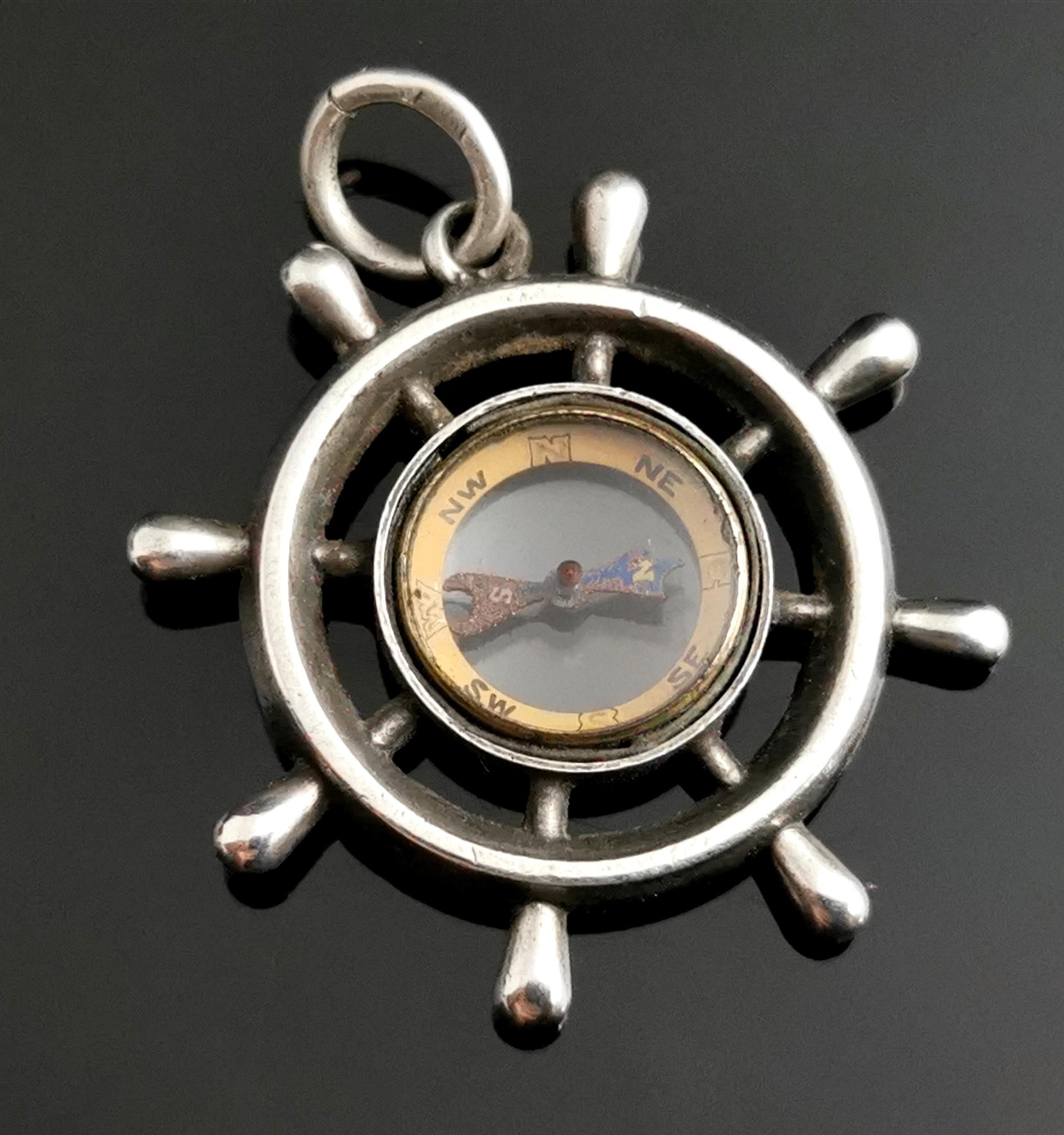 A fantastic antique, Victorian compass fob pendant designed as a ships wheel.

This is a nice sized piece, crafted in sterling silver, well designed as a ships wheel with a central working compass.

The compass is finished in gilt.

This would make