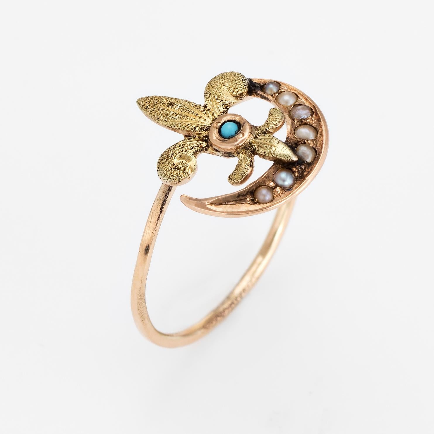 Originally an antique Victorian era stick pin (circa 1880s to 1900s), the fleur de lis & crescent moon ring is crafted in 14 karat yellow gold. 

The ring is mounted with the original stick pin. Our jeweler rounded the stick pin into a slim band for