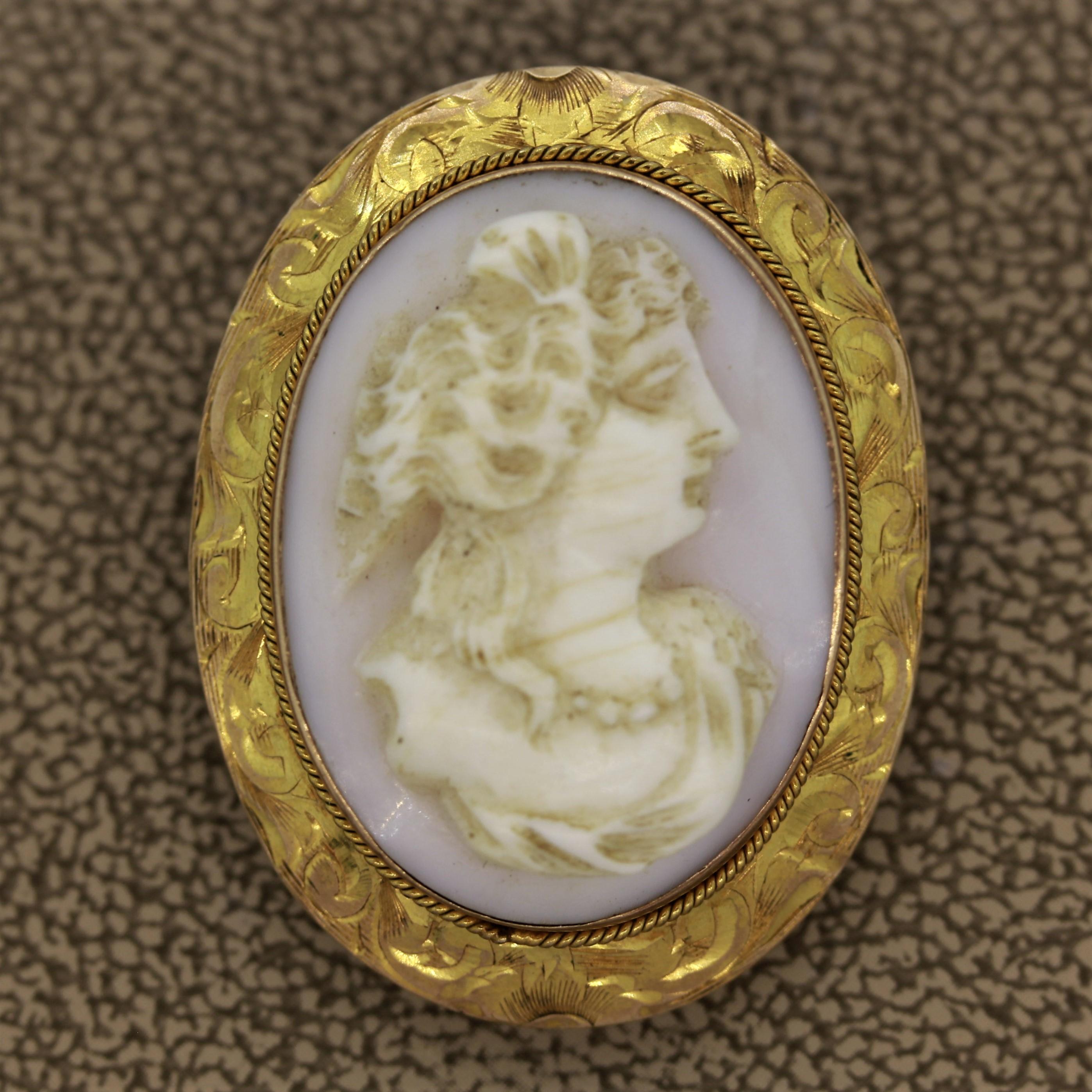 A more refined and rarer cameo made of natural “angel skin” coral. The 10k yellow gold frame was hand-made in the 19th century and the fine workmanship can be seen in the details. A braided gold boarder and filigree on the frame show its quality.

