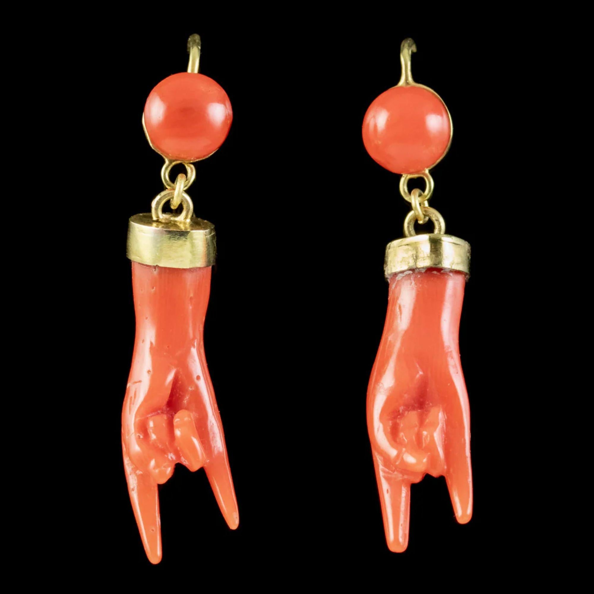 A wonderful pair of antique coral earrings made in Italy in the mid 19th Century. They depict two hand carved coral hands making a Corna (“horn”) gesture and have a lovely deep red/ orange colour that is produced naturally in the depths of the
