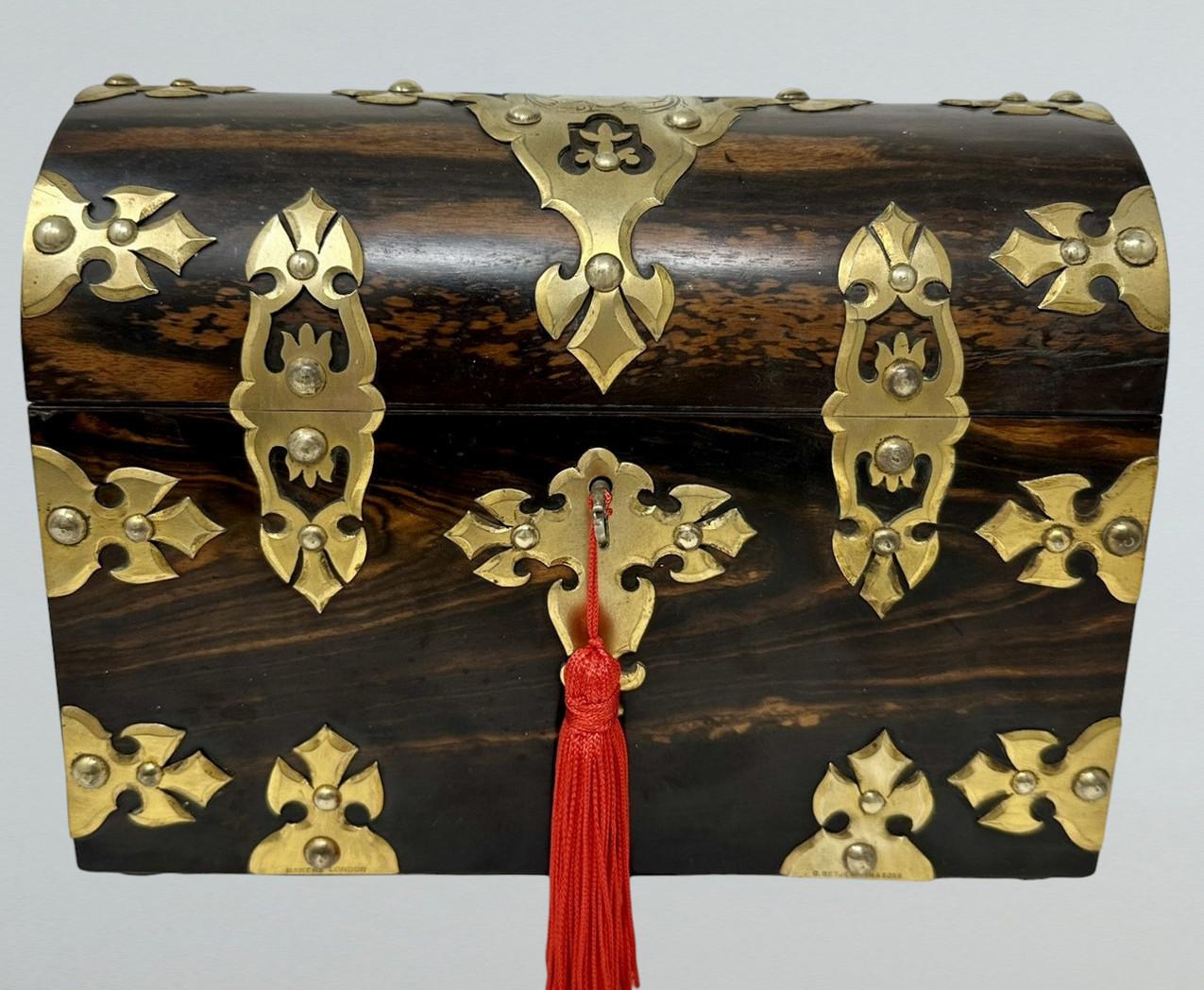 Absolutely stunning early Victorian well figured Coromandel Stationery Casket of museum quality and in outstanding condition. Mid Nineteenth Century. Made in England by G. Betjemann.  
The main outer carcass with lavish polished brass decoration.