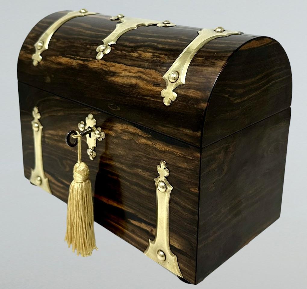 Absolutely stunning early Victorian well figured Coromandel Stationery Casket of museum quality and in outstanding condition. Mid to late Nineteenth Century, of English origin.  

The main outer carcass with lavish polished brass decoration. The