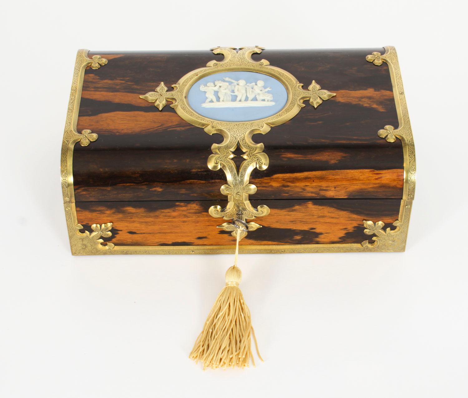 A Victorian ormolu and Jasperware cameo mounted coromandel jewellery casket,  Circa 1880 in date.

The rectangular dome-topped casket features Gothic revival brass mounts tooled with scrolling foliage which frame a central cartouche inset with a