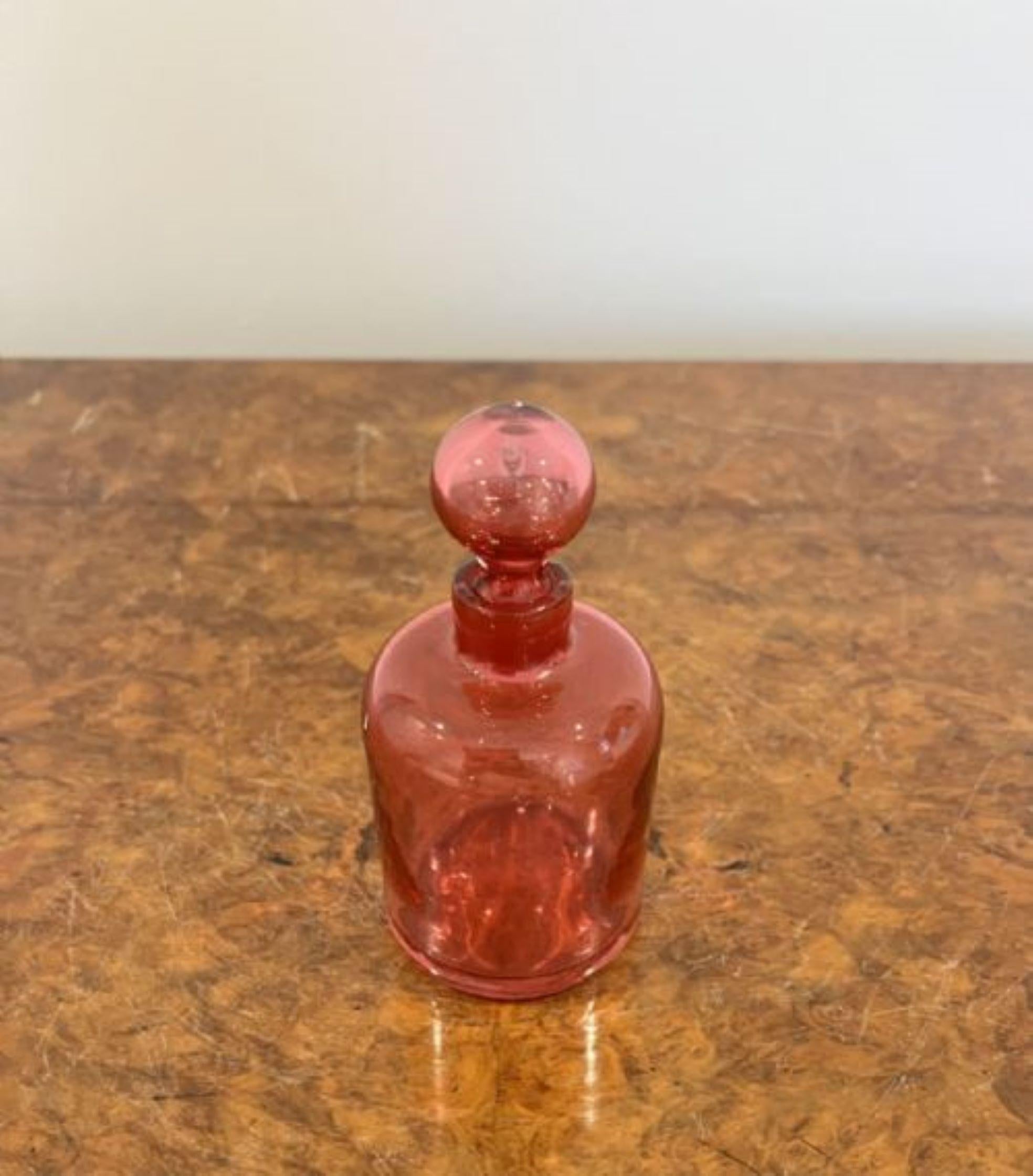 Antique Victorian cranberry glass bottle, having a cranberry glass bottle with the original cranberry glass stopper 