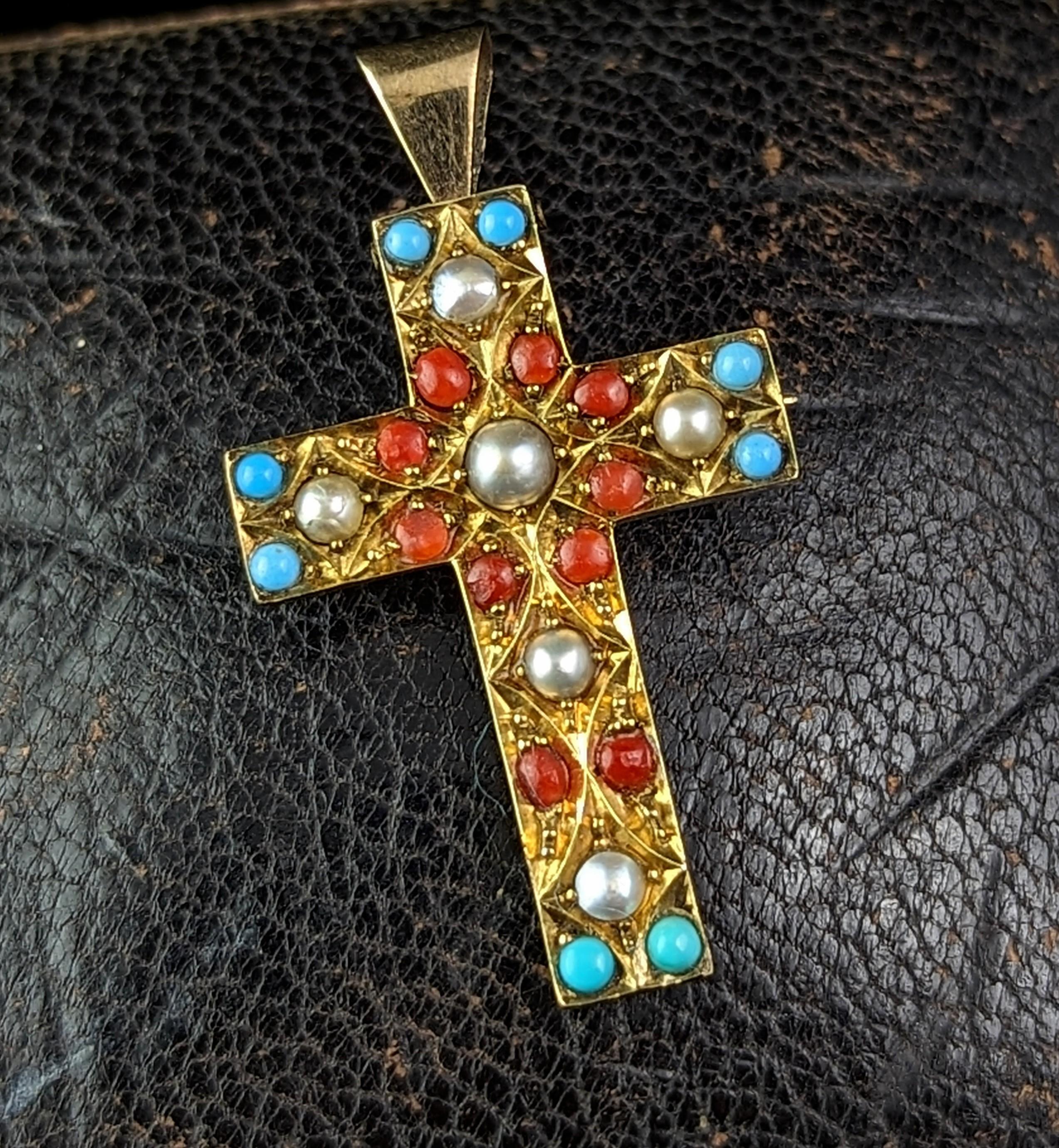 A magical antique Victorian era cross pendant brooch.

The cross has an engraved front and is adorned with creamy seed pearl along with coral and turquoise coloured paste stones.

It has an unusual and vibrant style which really makes it stand out