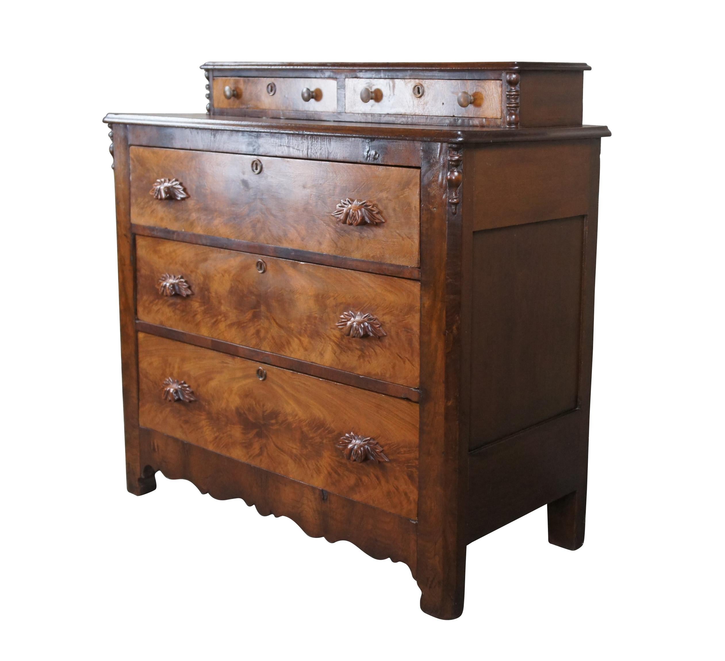 A beautiful antique American Victorian era stepback dresser, circa 1870s.  Made from poplar and walnut with three hand dovetailed standard drawers below two upper glovebox drawers.  Features crotch walnut veneer along drawer fronts, hand carved