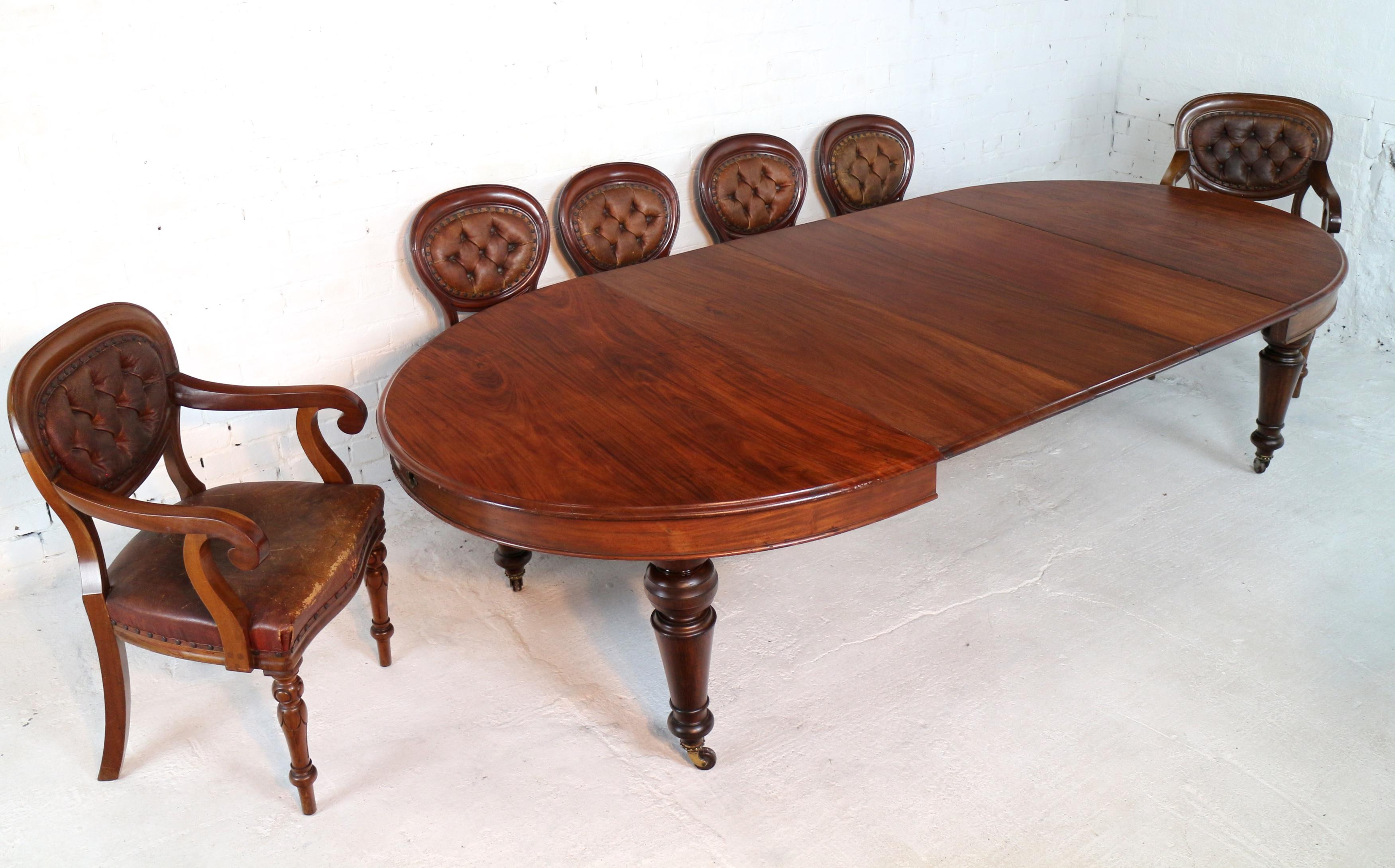 A super Victorian extending dining table in figured Cuban mahogany and with three additional leaves. Dating to circa 1870 this classic is of the rarer oval ended shape with a moulded edge and stands on four turned and faceted tapering legs with