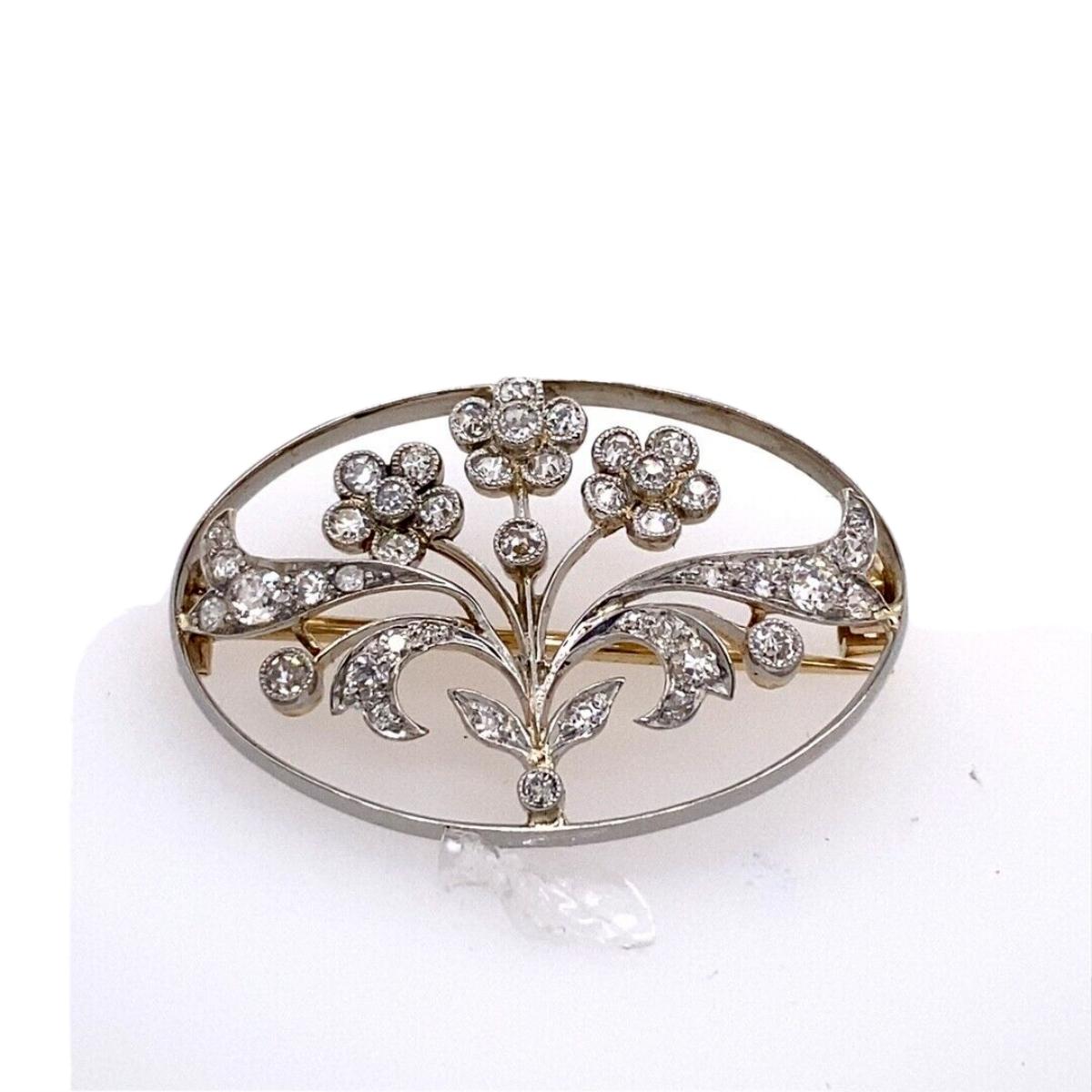 Antique 15ct Yellow & White Gold With Victorian Cut Diamonds Oval Floral Brooch

This stunning brooch in 14ct White Gold set with 6 Victorian cut natural Diamonds and small Diamonds set on leaves, with total Diamond weight features a 1.20ct F/G