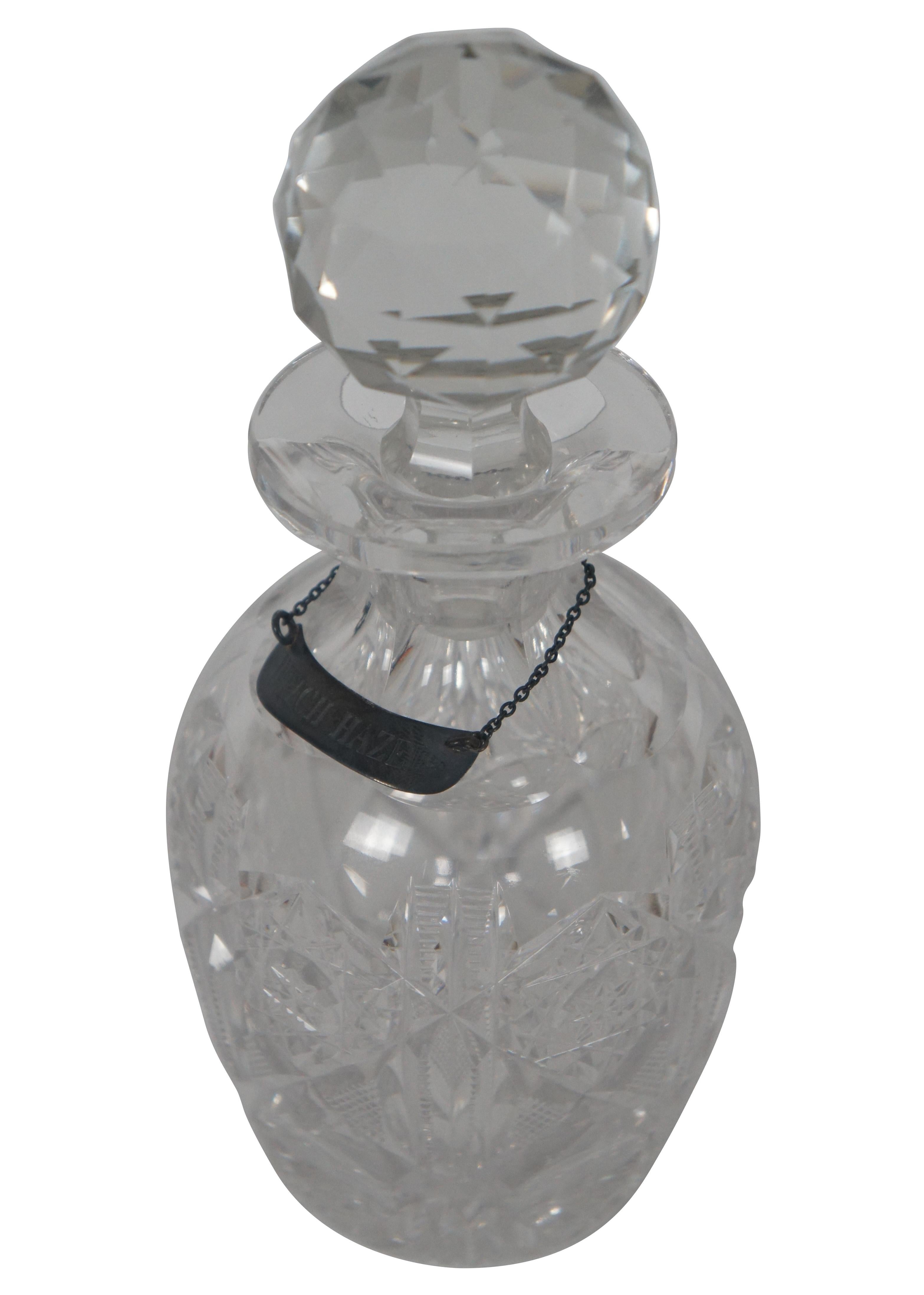 Antique cut glass vanity bottle and stopper with metal label marking the bottle for witch hazel, a popular astringent.