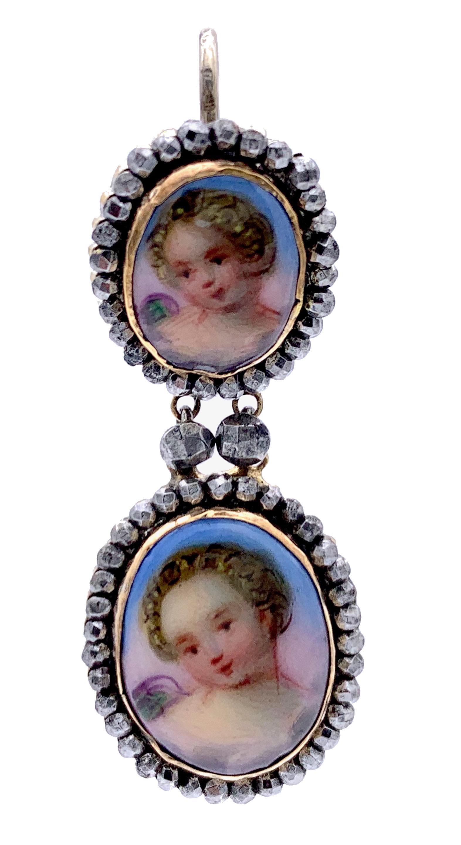 Very rare Victorian dangling earrings made out of cut steel and painted porcelain plaques depicting cherubs.  