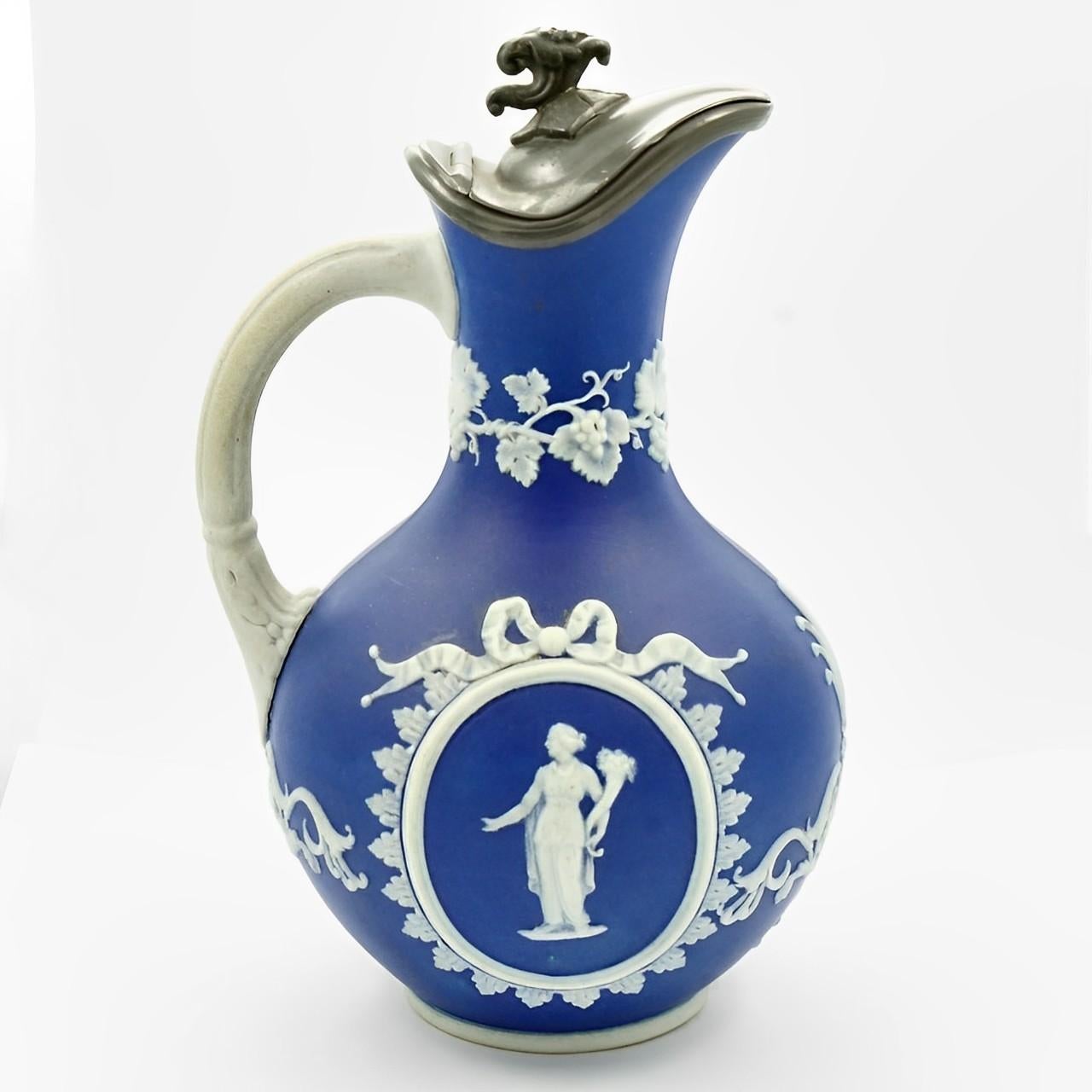 Beautiful antique Victorian dark cobalt blue jug with a pewter lid. Featuring classical relief figures and a grapevine edging. Measuring height 16.5 cm / 6.5 inches, and approximately diameter 9 cm / 3.5 inches. The jug is in very good condition for
