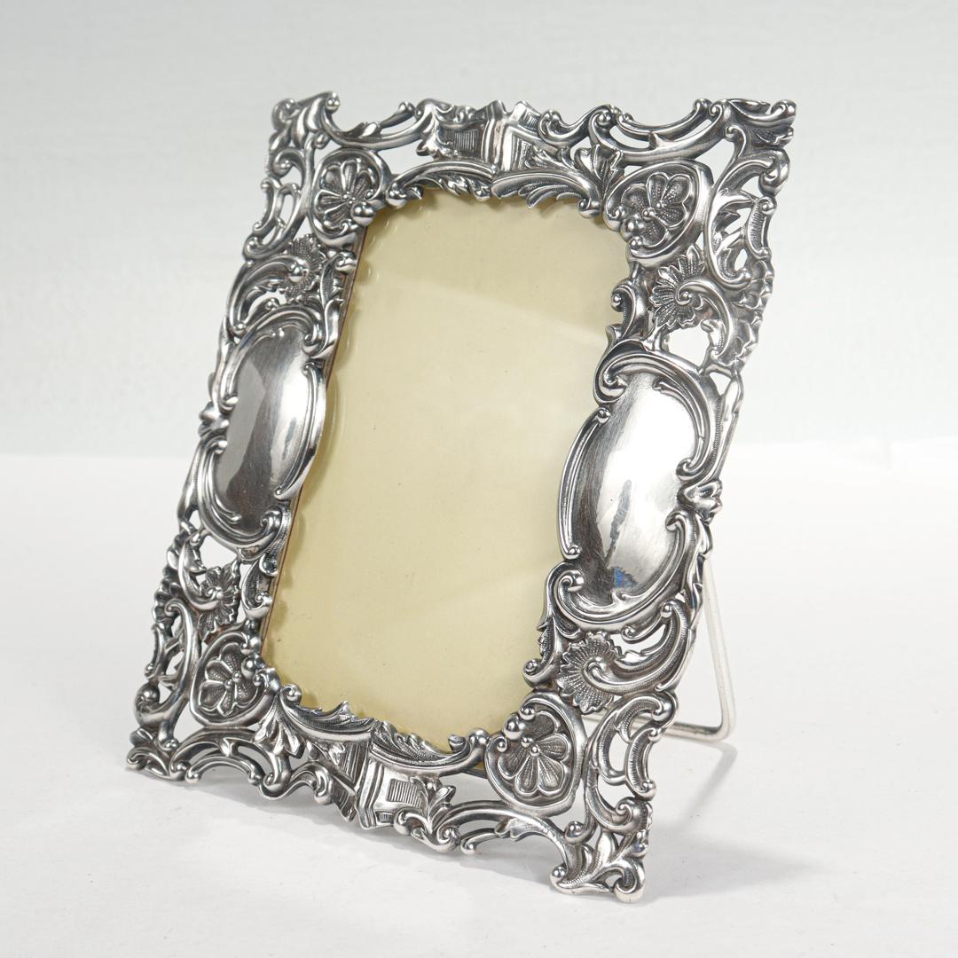 A fine ornate antique Victorian frame.

In quadruple plate silver plate.

By the Derby Silver Company.

With an ornate piercing and openwork to the edge of the frame, a hinged easel back, and an open slot for a picture and glass to the reverse.