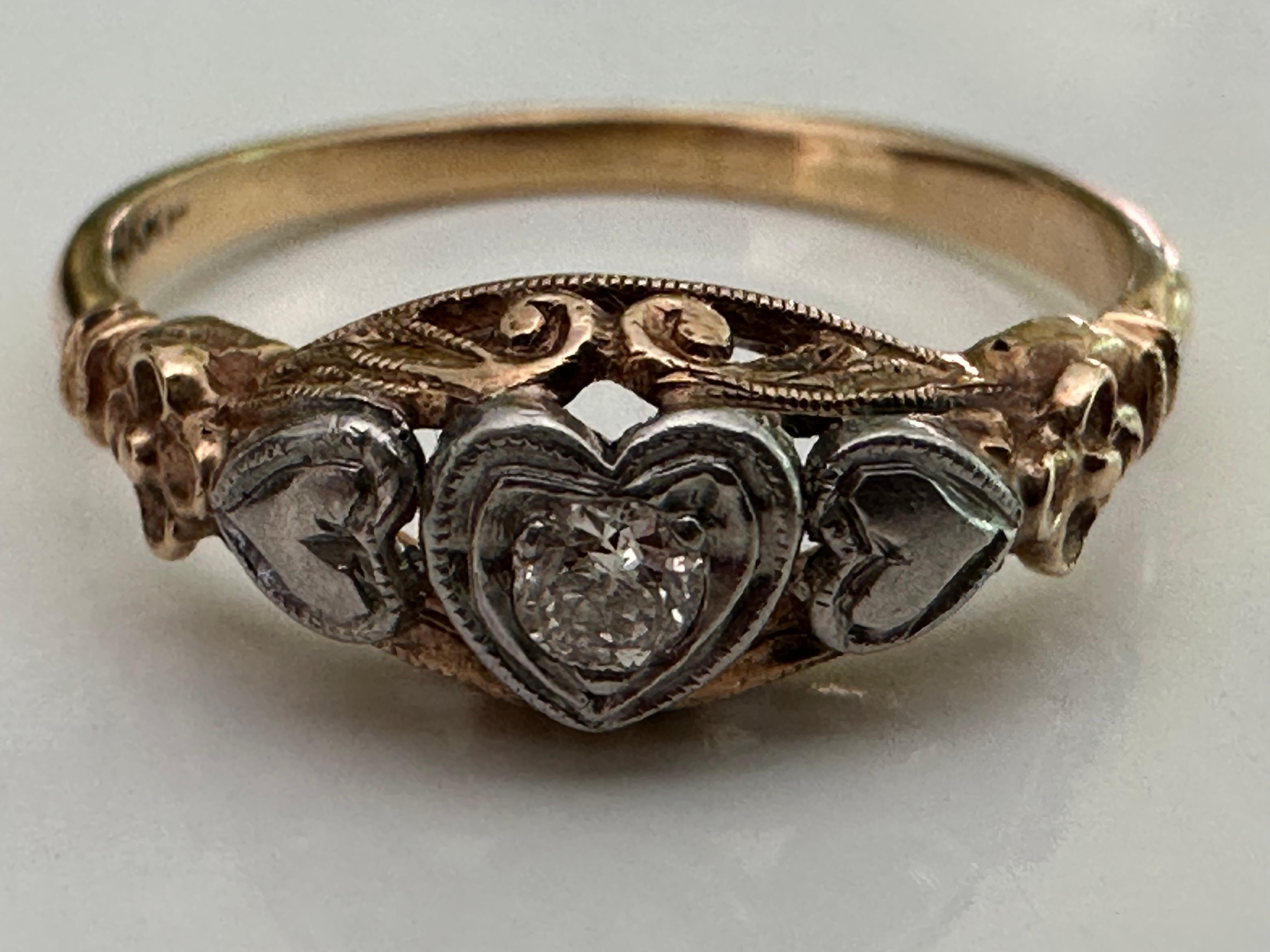 This delicate ring features a 0.05-carat Old European cut diamond center stone, H color, VS clarity, set within a platinum heart-shaped collet setting and fashioned in a 14K yellow gold filigree band.  Circa late 19th century. 


