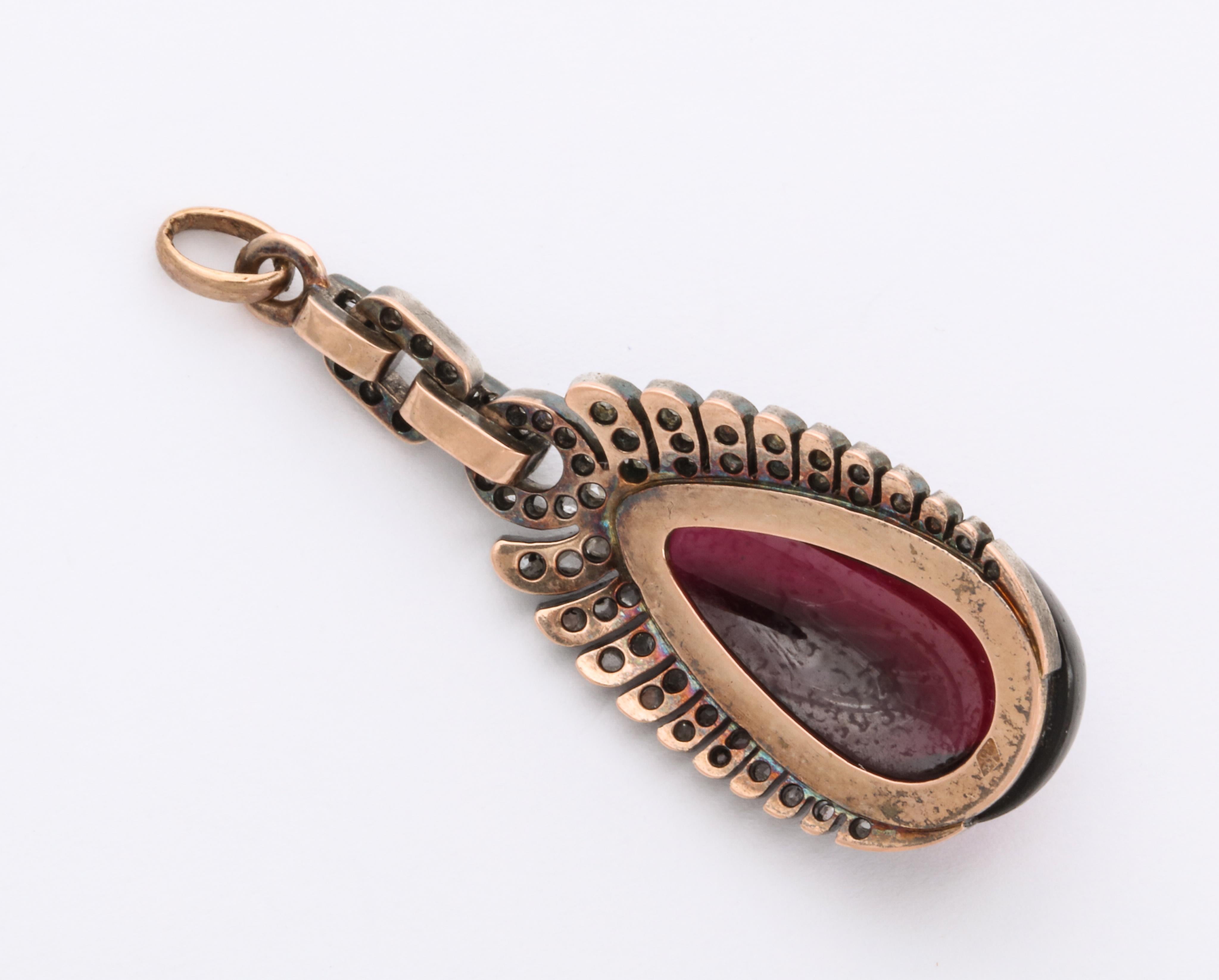 As though the heart has wings, this sumptuous pendant, a raised domed teardrop of garnet has antique diamond wings and superior workmanship. It is an original from c. 1860-1870. The beauty of the red and white and the fine work attracted many