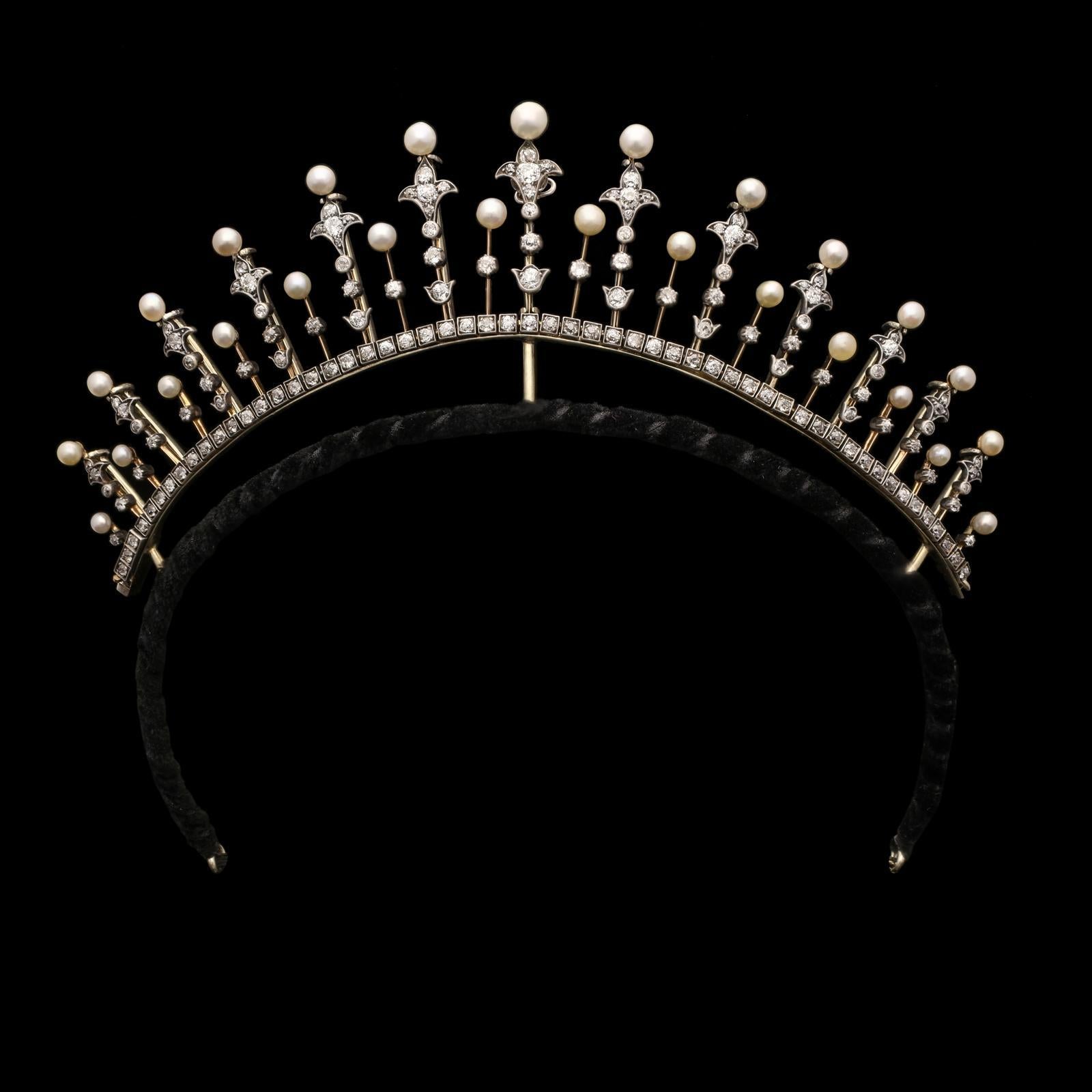 A beautiful Victorian diamond and pearl tiara c.1890, designed as a graduated fringe of knife-edge spires set with old cut diamonds and topped with natural cream round pearls, the dominant spires feature a lily motif at the base with a single