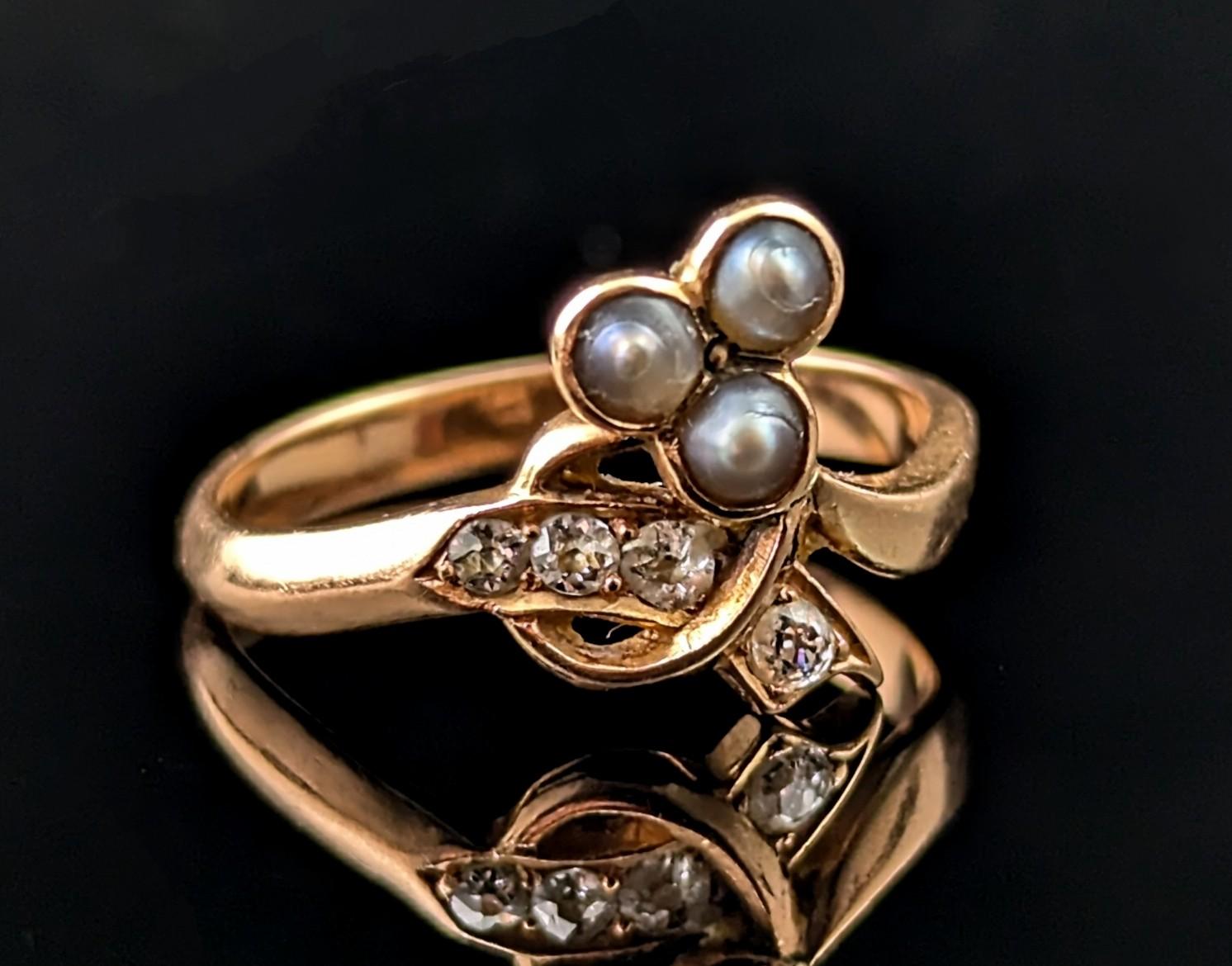 This gorgeous antique Victorian era Diamond and Pearl shamrock ring really stands out from the crowd.

Crafted in rich 18ct rose gold it has a nice chunky d profile band terminating at the face with a shamrock design.

The shamrock leaves are set