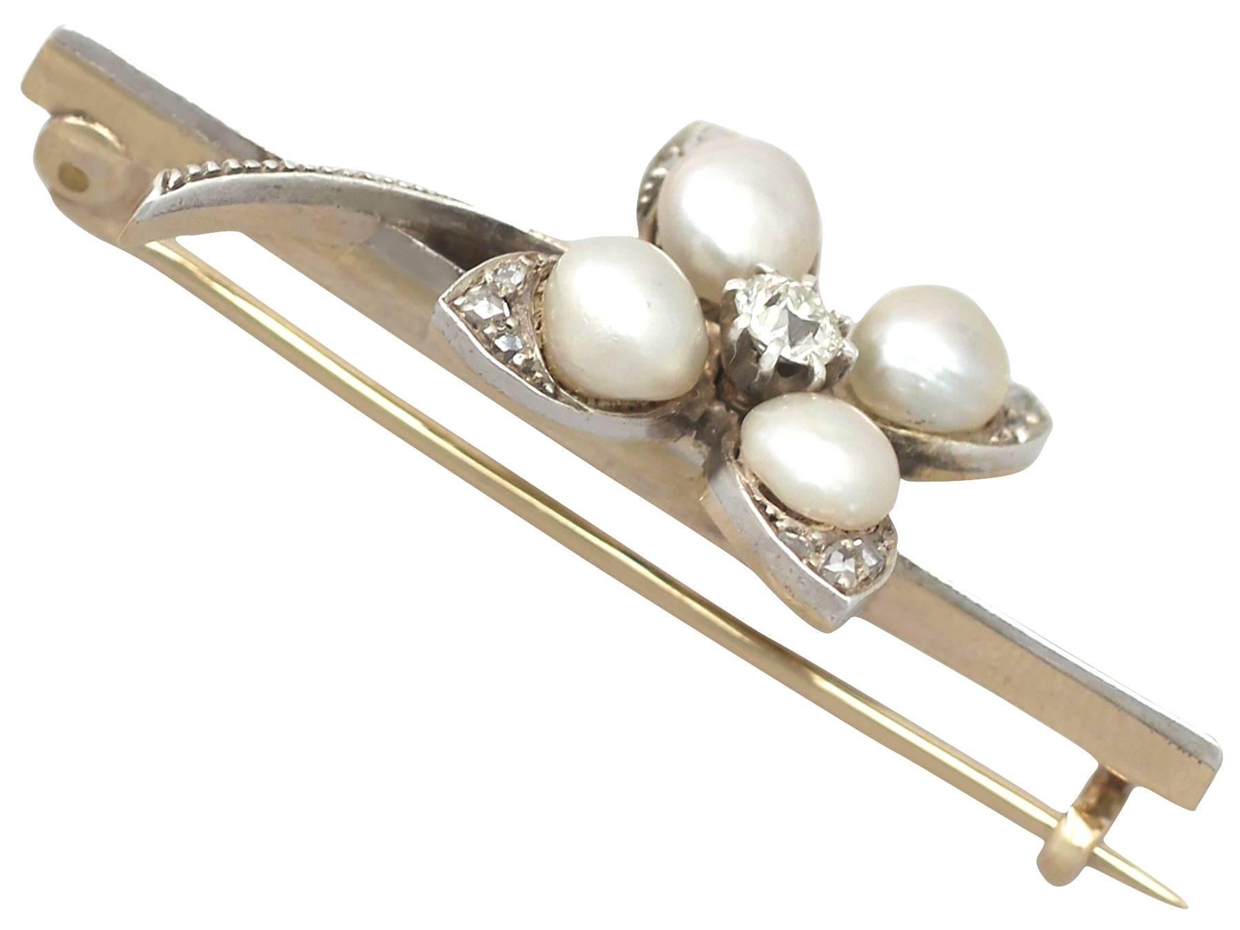 A fine and impressive antique 0.26 carat diamond and natural pearl, 12 karat yellow gold and silver set clover, bar style brooch; part of our antique jewelry/estate jewelry collections.

This fine and impressive antique Victorian clover brooch has