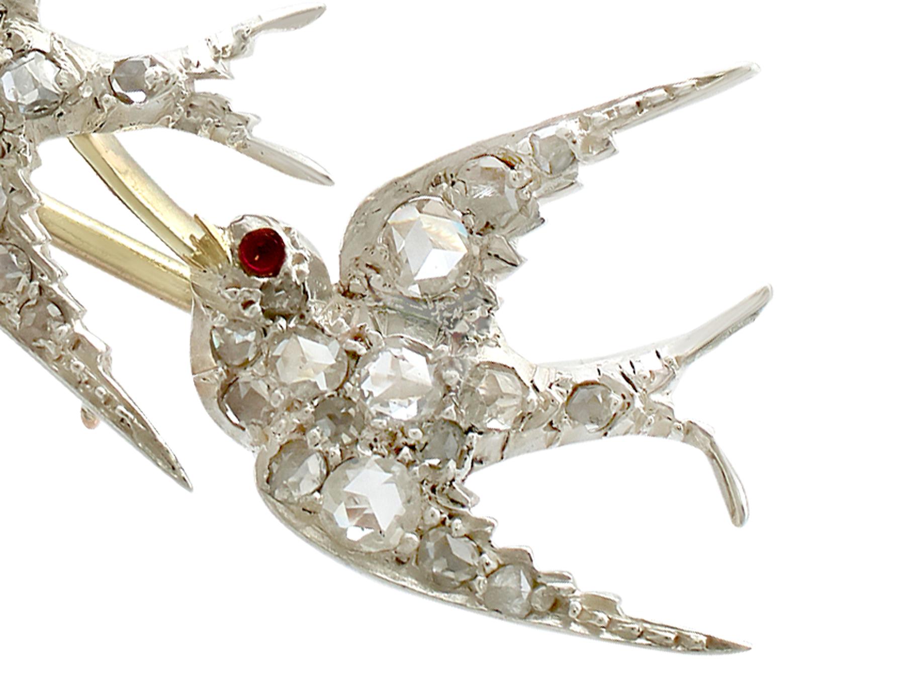 An impressive antique Victorian 0.31 carat diamond and 0.03 carat ruby, 12 karat yellow gold and silver set swallow brooch; part of our diverse antique jewelry collections.

This fine and impressive Victorian bird brooch has been crafted in 12k