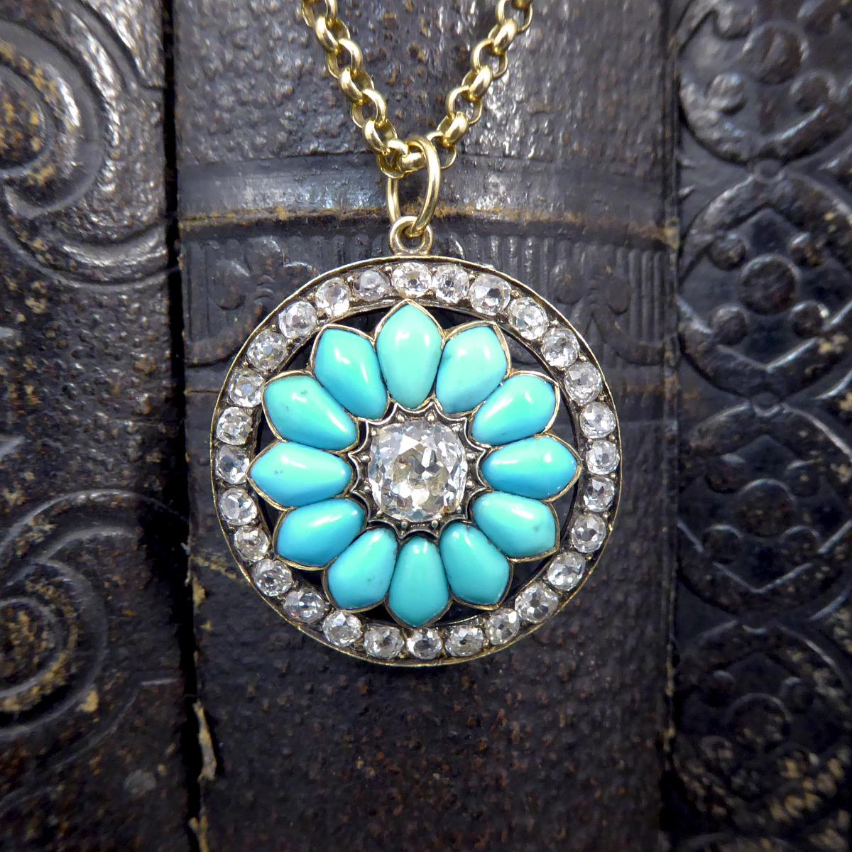 This gorgeous quality antique pendant holds a cushion cut Diamond weighing 1.20ct in the centre of the flower with turquoise stones as its petals. With a circular surround of old cut Diamonds there is a total of 3.20ct all set in 15ct Gold. The