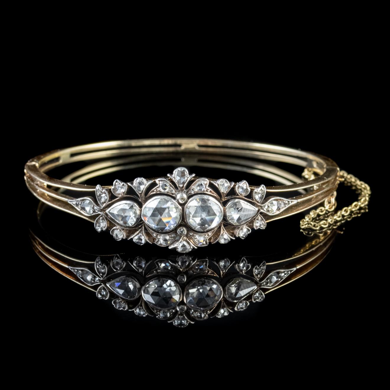 This striking antique Victorian bangle is adorned with a stunning array of Rose cut Diamonds spread out across the decorative face totalling to approx. 4ct with the largest stones weighing around 1.25ct each.   

The rose cut Diamonds resemble the