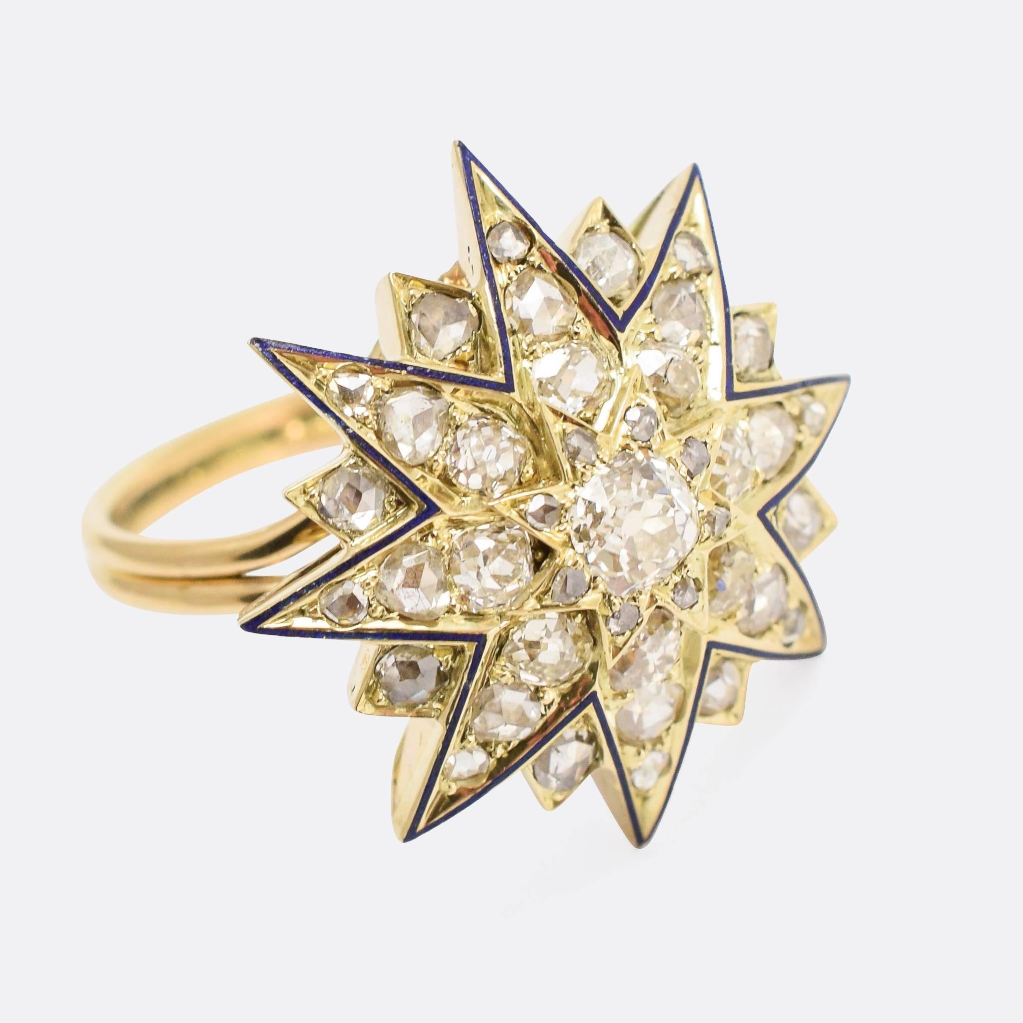 An incredible star ring converted from a Victorian era brooch. The head is set with around 1.8 carats of old mine cut diamonds, and finished in fine deep blue enamel. The head rests on a gold reeded band, and maintains a low profile against the