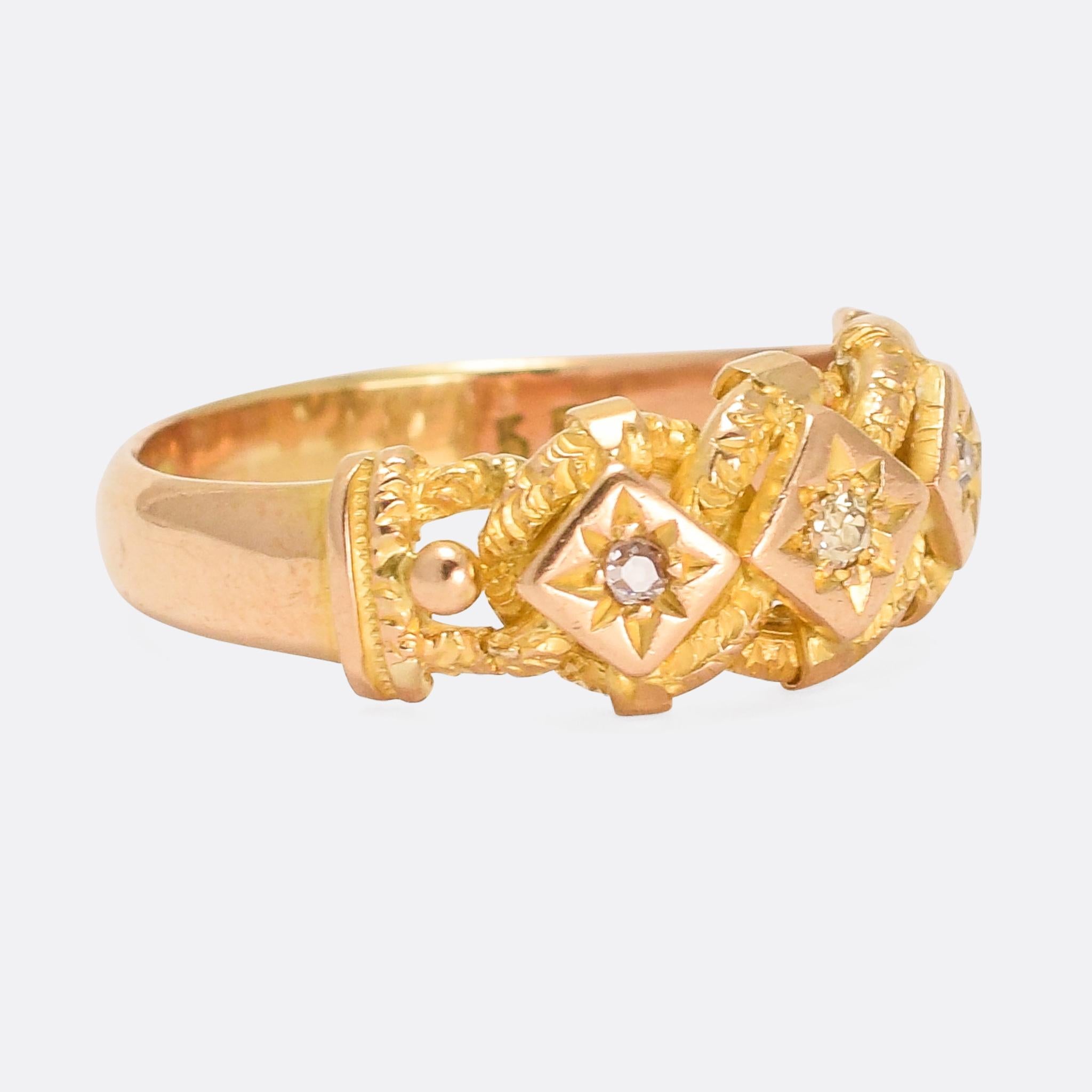 A quality antique three-stone keeper ring dating from 1870. The diamonds rest in stylised star mounts, each of which sits in the middle of a curb chain link. It's modelled in 18 karat gold, with a good substantial feel to it and interesting chased