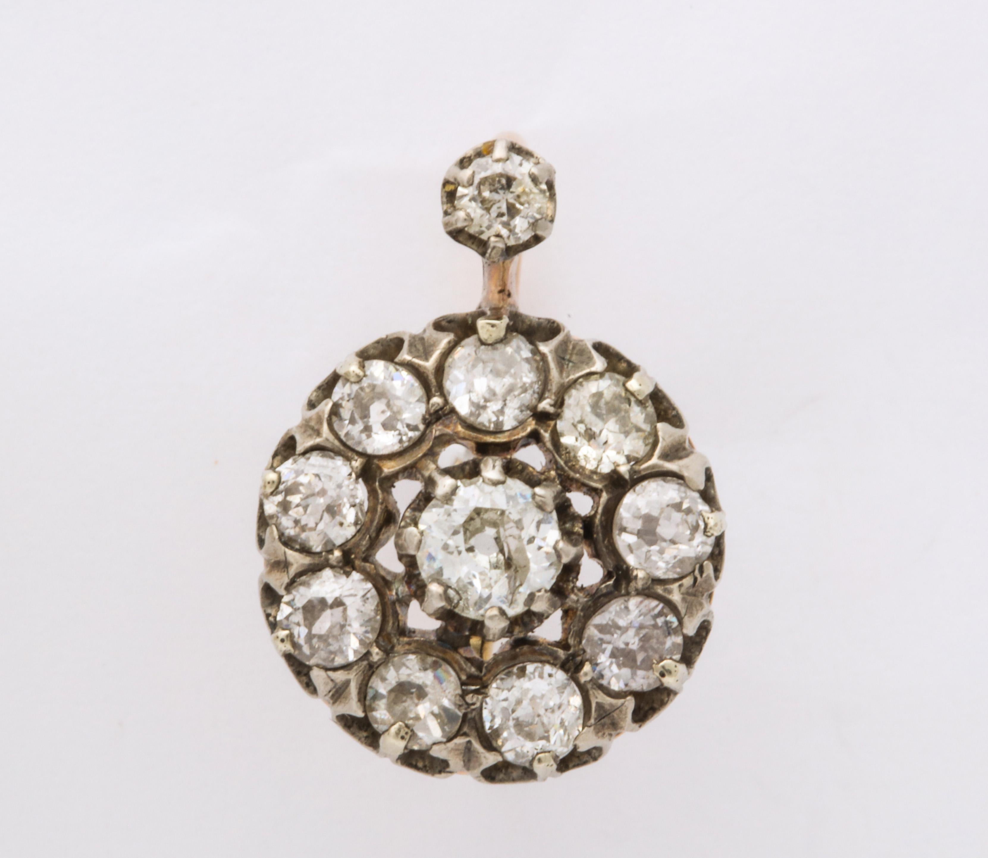 Bright, white diamonds old mine and european cut, look brilliant in these dropped cluster earrings from the Victorian collection. Approximate total weight in situ 2.5cts. The setting is 15kt gold covered with silver around the diamonds so as not to