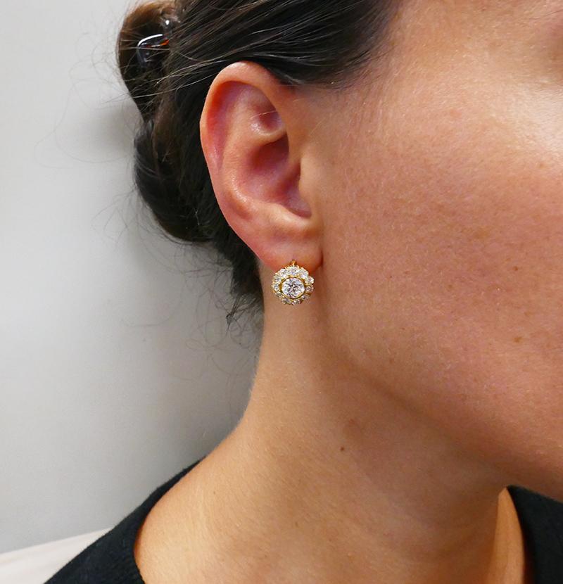         A fabulous pair of Victorian earrings in 18k gold, featuring antique, hand-cut diamonds, with a classic cluster design.
	The open back claw setting allows a larger amount of light enter the diamonds. It truly reveals the beauty of the