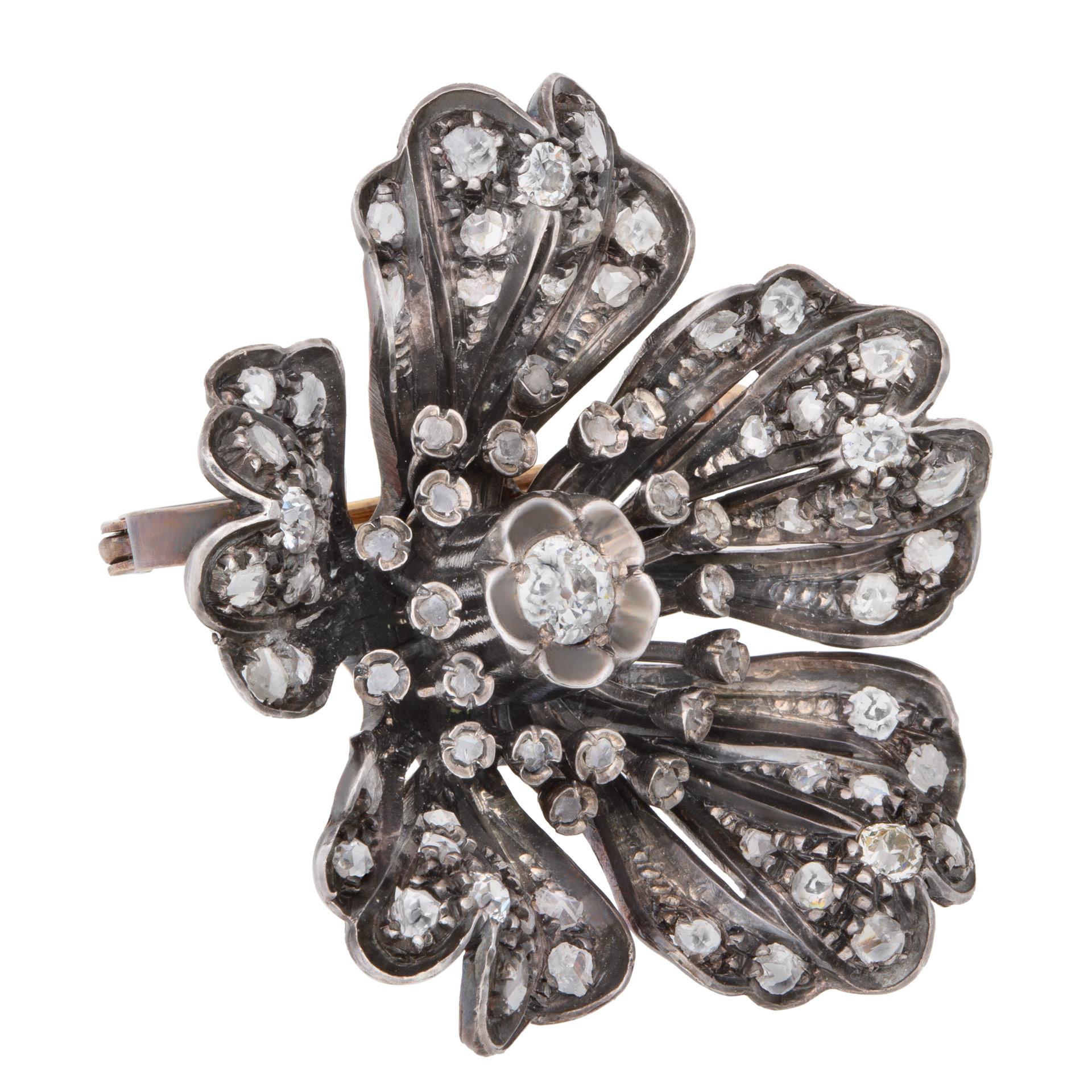 Antique victorian flower brooch/pin/pendant with silver top and gold with over 2 carats in old mine diamonds. Size 1.50 inches by 1.50 inches.
