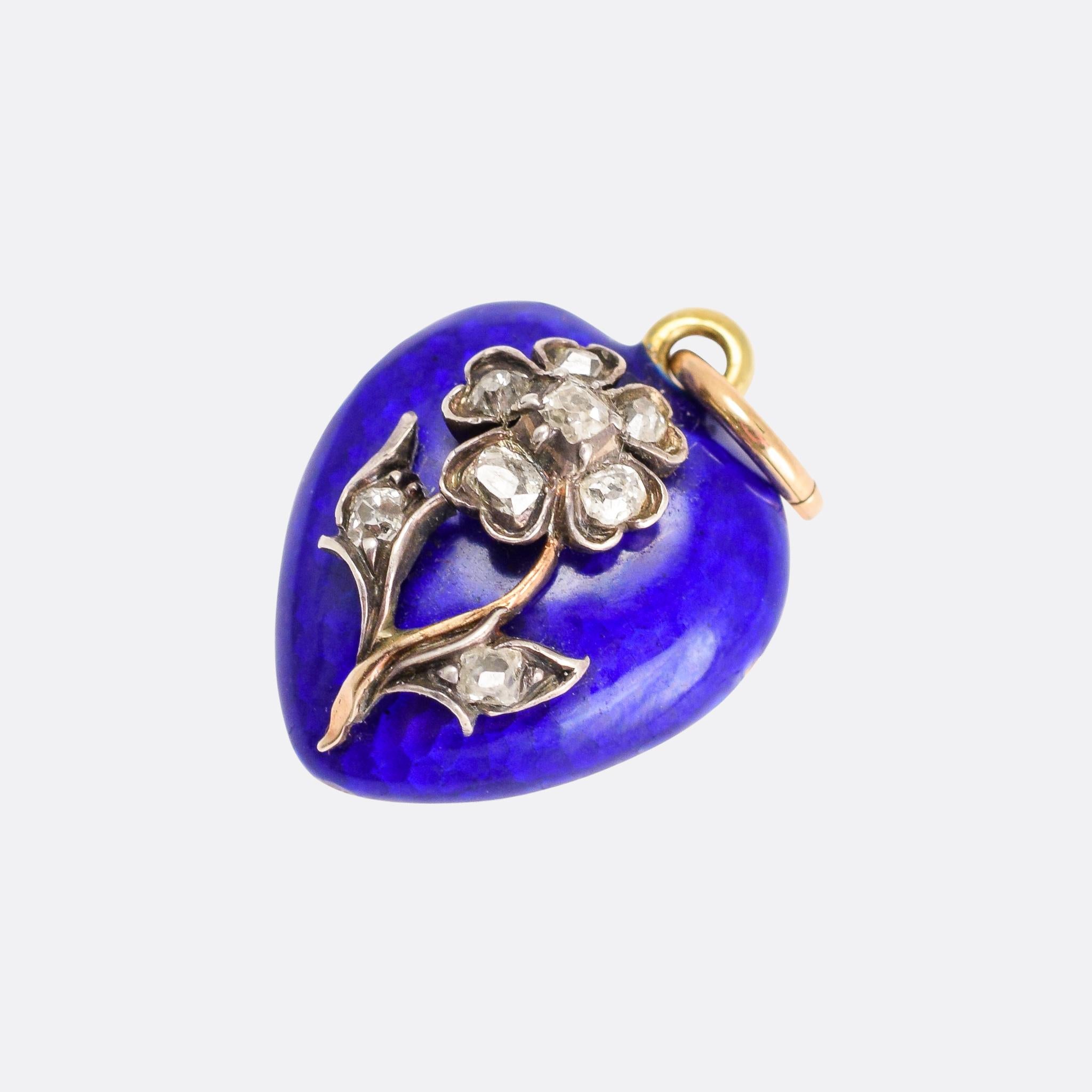 An adorable antique heart locket, the front finished in royal blue guilloché enamel and featuring an applied diamond-set Forget-Me-Not flower. It dates from the mid-Victorian era, circa 1860, and the craftsman ship is simply exceptional. Set with