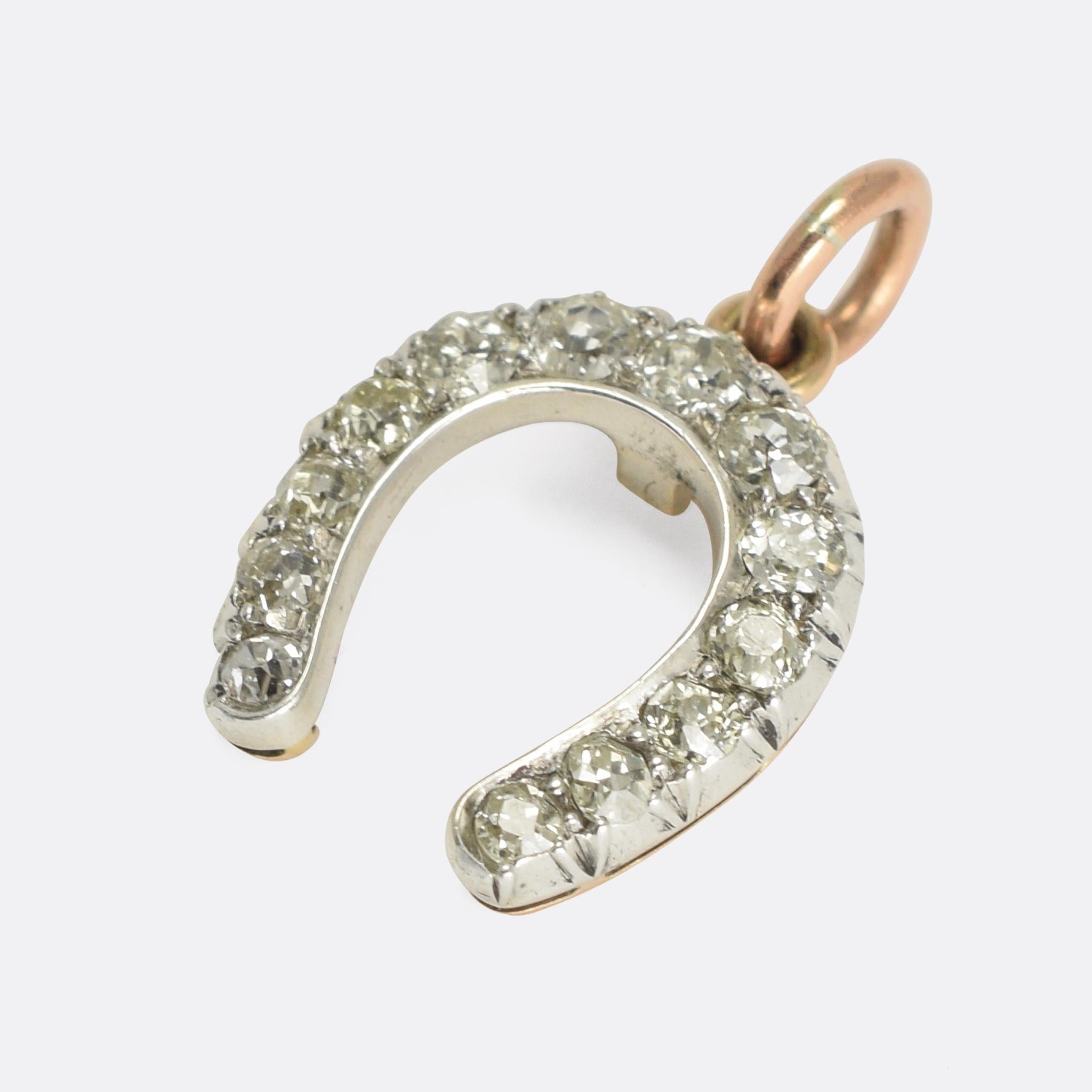 An especially lovely antique horseshoe pendant set with 13 graduated old mine cut diamonds. The stones rest in silver mounts with a 15k gold back. 

STONES 
Old mine cut diamonds

MEASUREMENTS 
1.8 x 1.4cm

WEIGHT 
2.0g

MARKS 
No marks present,