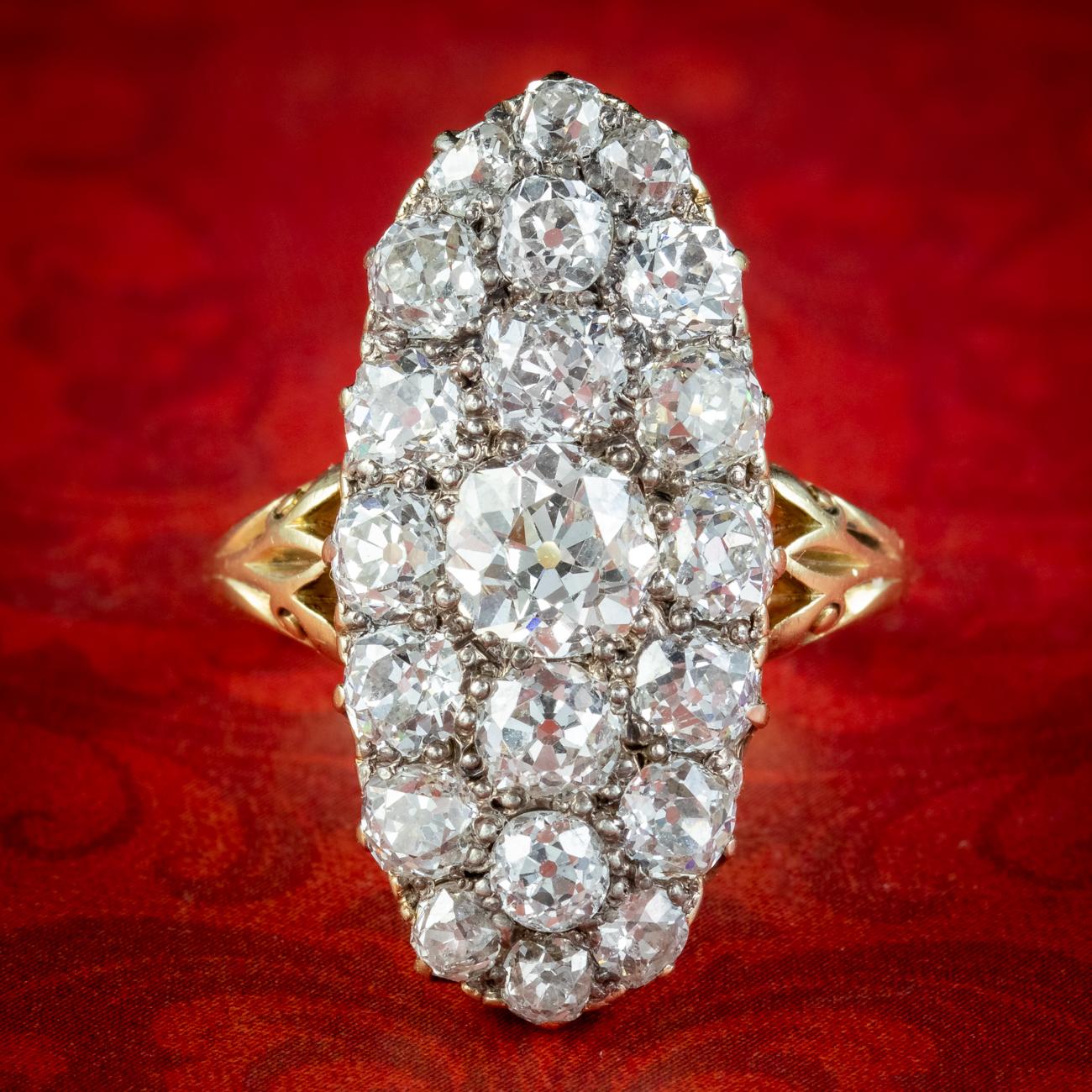 A magnificent antique Victorian cluster ring from the late 1800s encrusted with twenty-one glorious old mine cut diamonds across the elongated navette face.

The diamonds are superbly cut, chunky and dance endlessly in the light, with exceptional