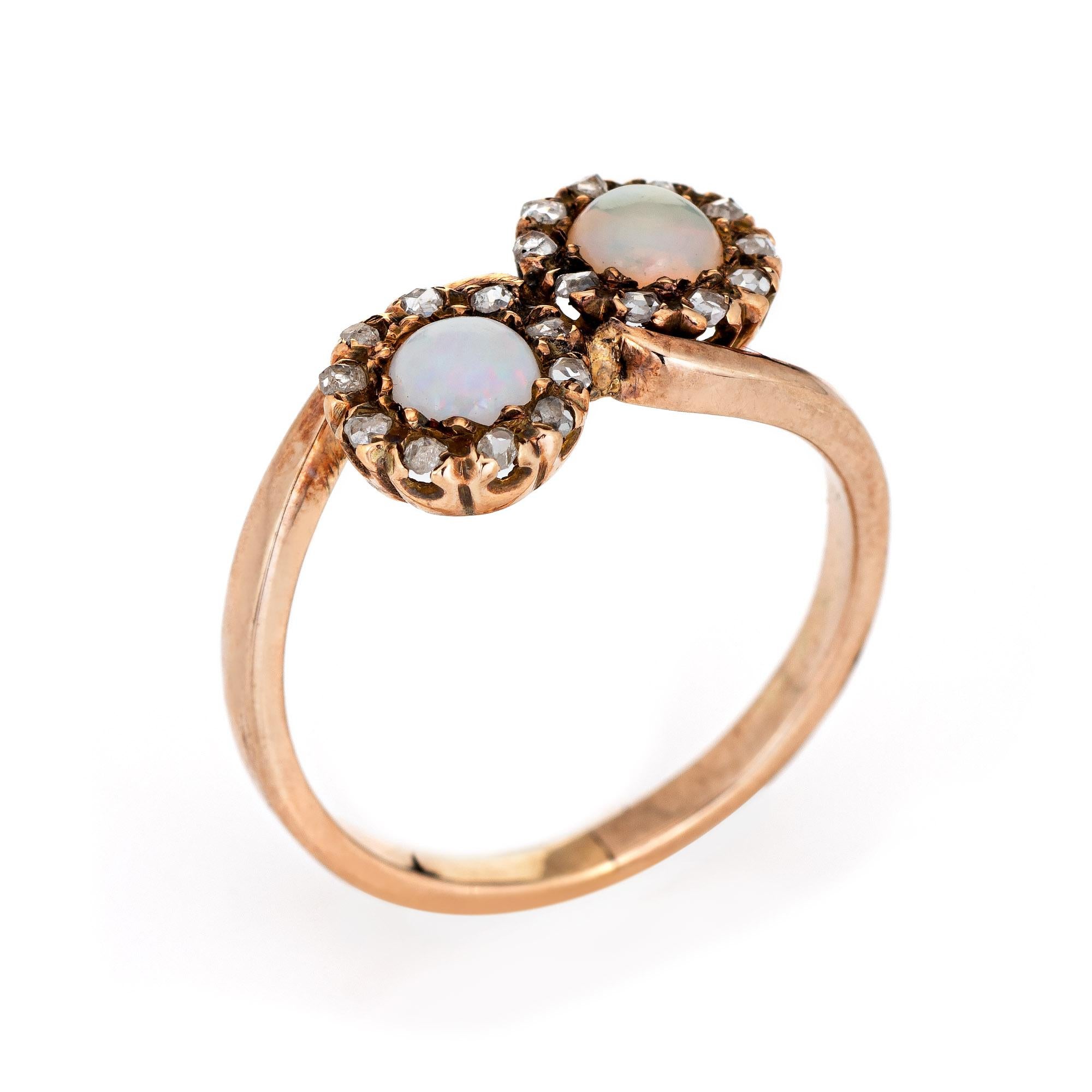 Finely detailed antique Victorian opal & diamond 'moi et toi' ring crafted in 10k yellow gold (circa 1880s to 1990s).  

Two opals each measure 5mm, accented with 20 estimated 0.01 carat old rose cut diamonds. The diamonds total an estimated 0.20