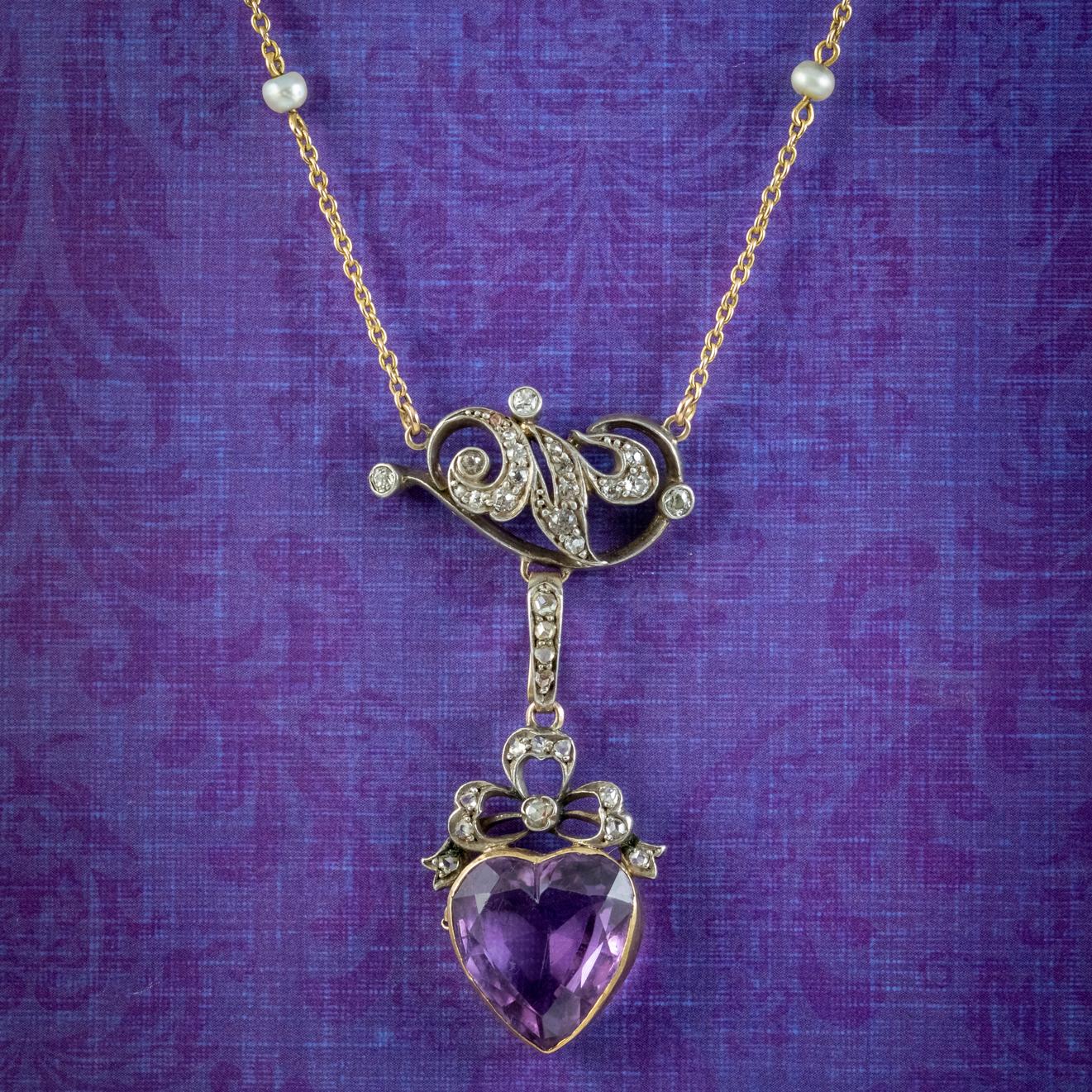 A fabulous Antique late Victorian lavaliere necklace adorned with a beautiful Art Nouveau style pendant decorated with twinkling Diamonds (approx. 1ct total) and a large Amethyst heart at the bottom weighing approx. 10ct.

The pendant consists of a