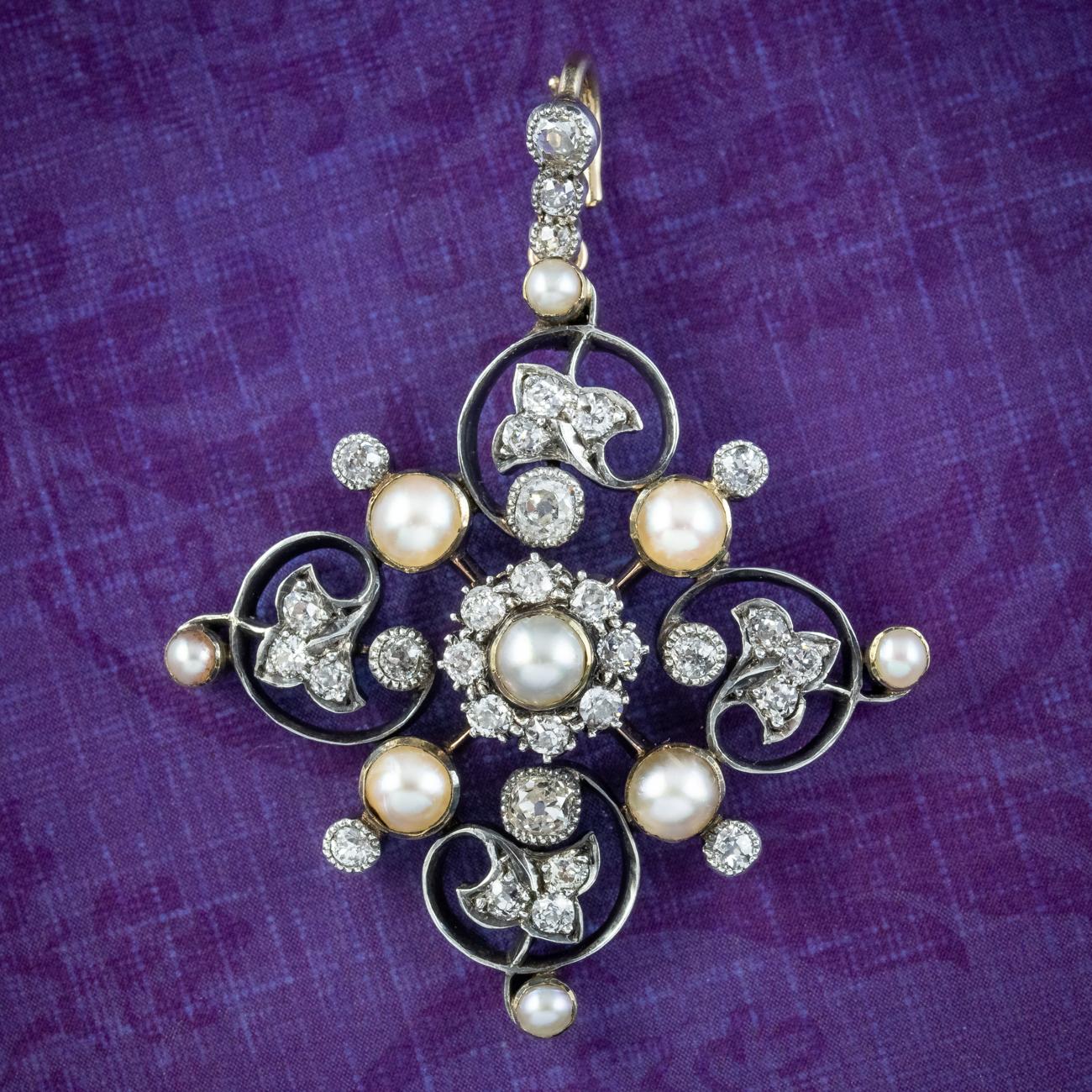 A stunning antique Art Nouveau pendant from the late Victorian era (Circa 1900) decorated with nine lustrous natural pearls and glistening old mine cut diamonds that total approx. 1.5ct. 

Pearls are the birthstone of June and a true treasure of the
