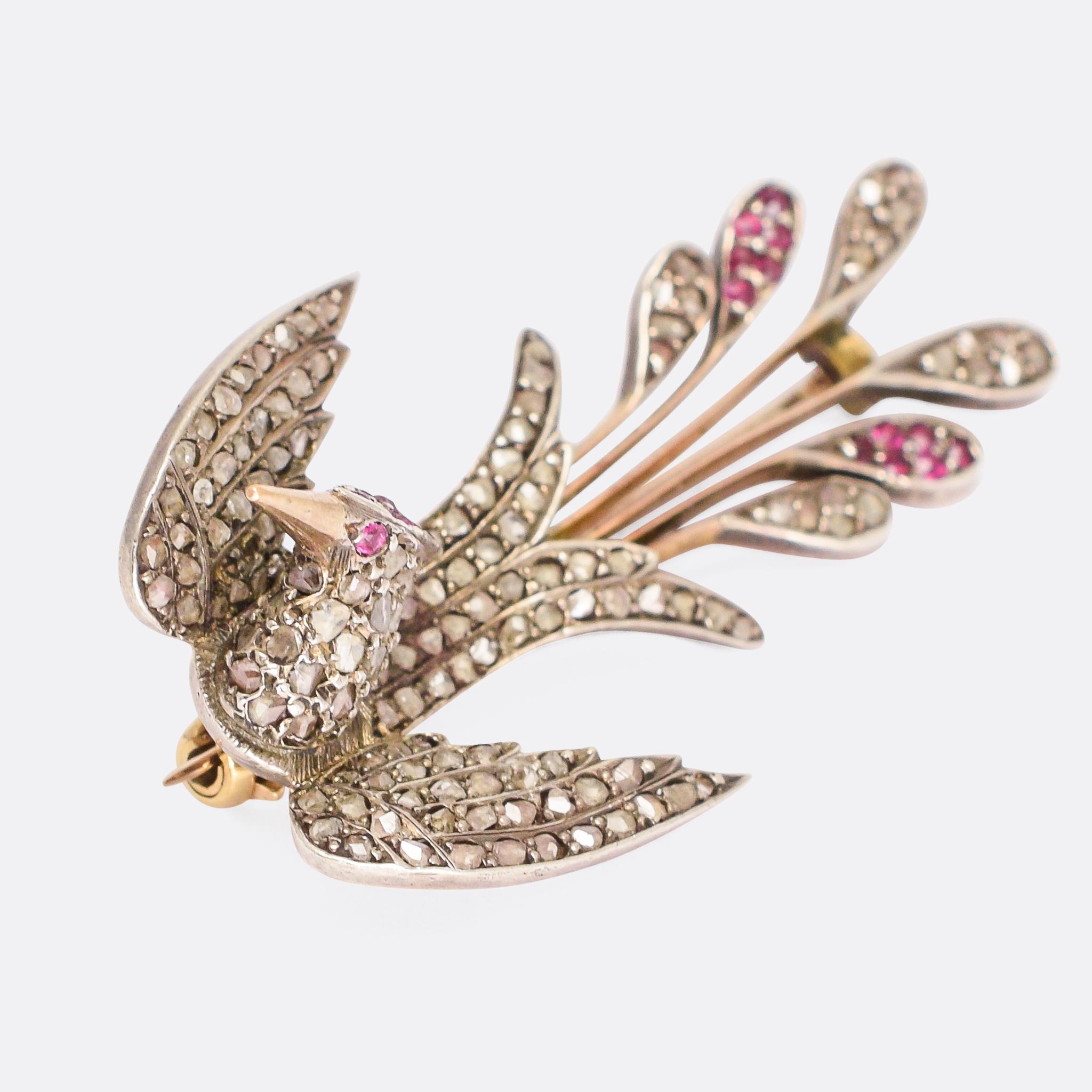 A stunning antique phoenix brooch, masterfully worked and fully set with rose cut diamonds and rubies. It’s perfectly formed, with a crest, elongated beak and a plume of fiery tail feathers. It dates from the Victorian period, modelled in 9 karat